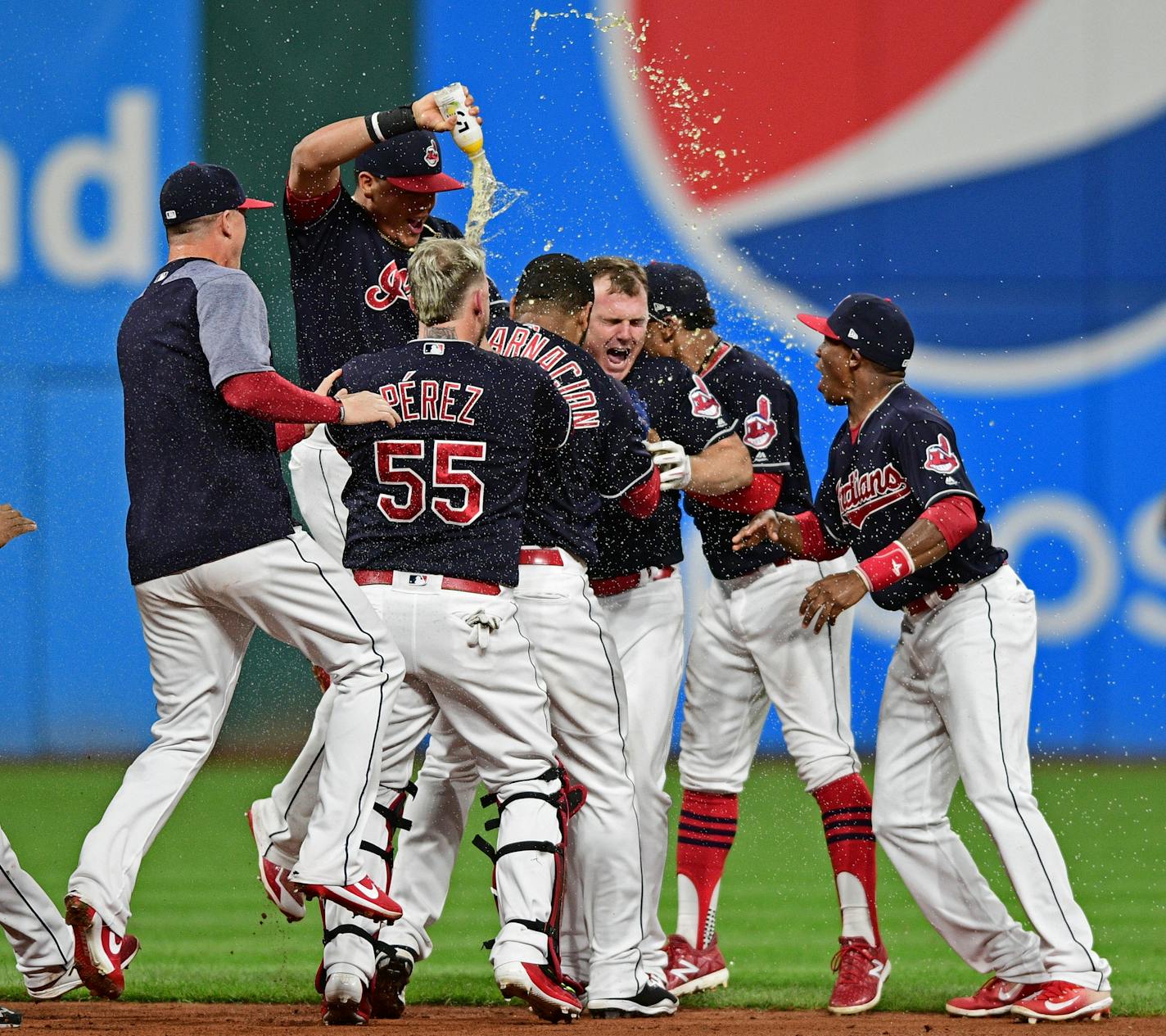 Cleveland Indians' Jay Bruce, center, celebrates with teammates after Bruce drove in the winning run on Sept. 14.