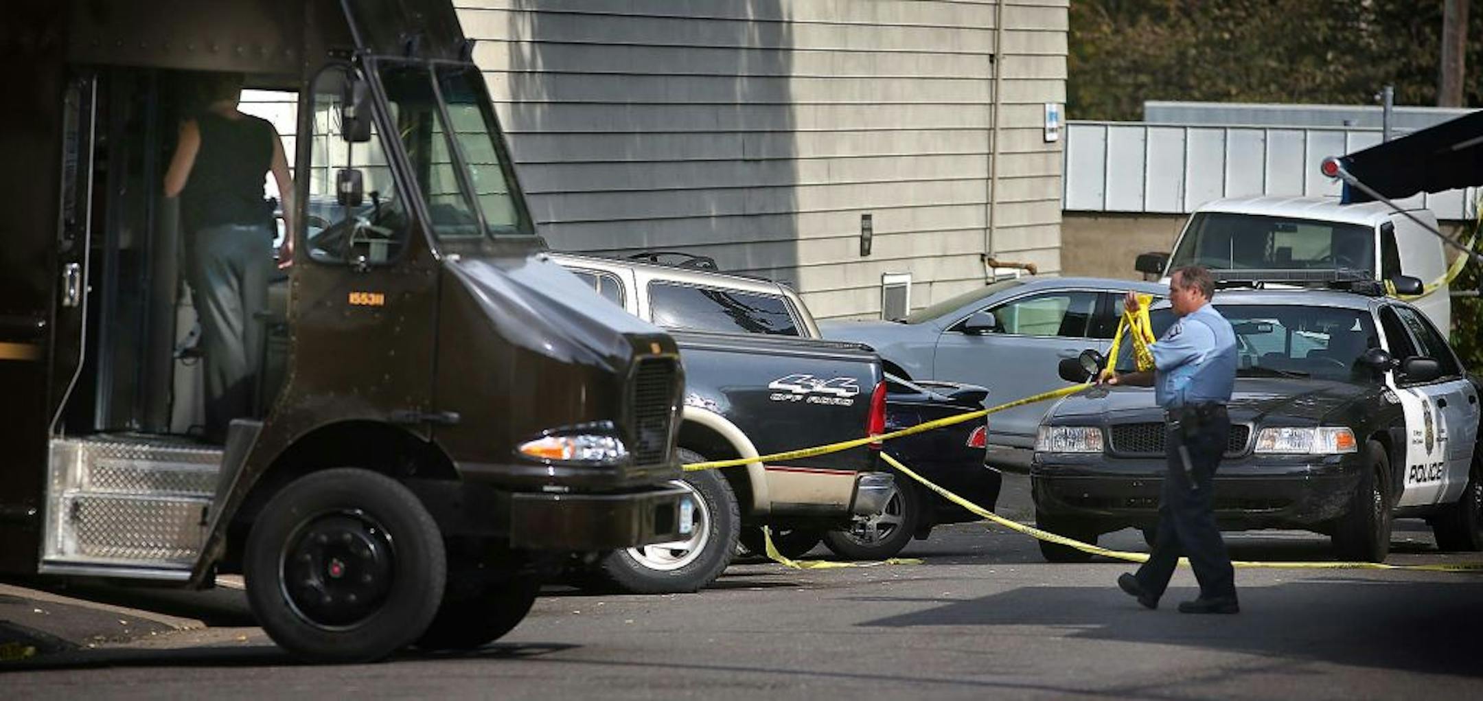 A Minneapolis officer picked up police tape as the response to the Sept. 27 shootings began to wrap up.