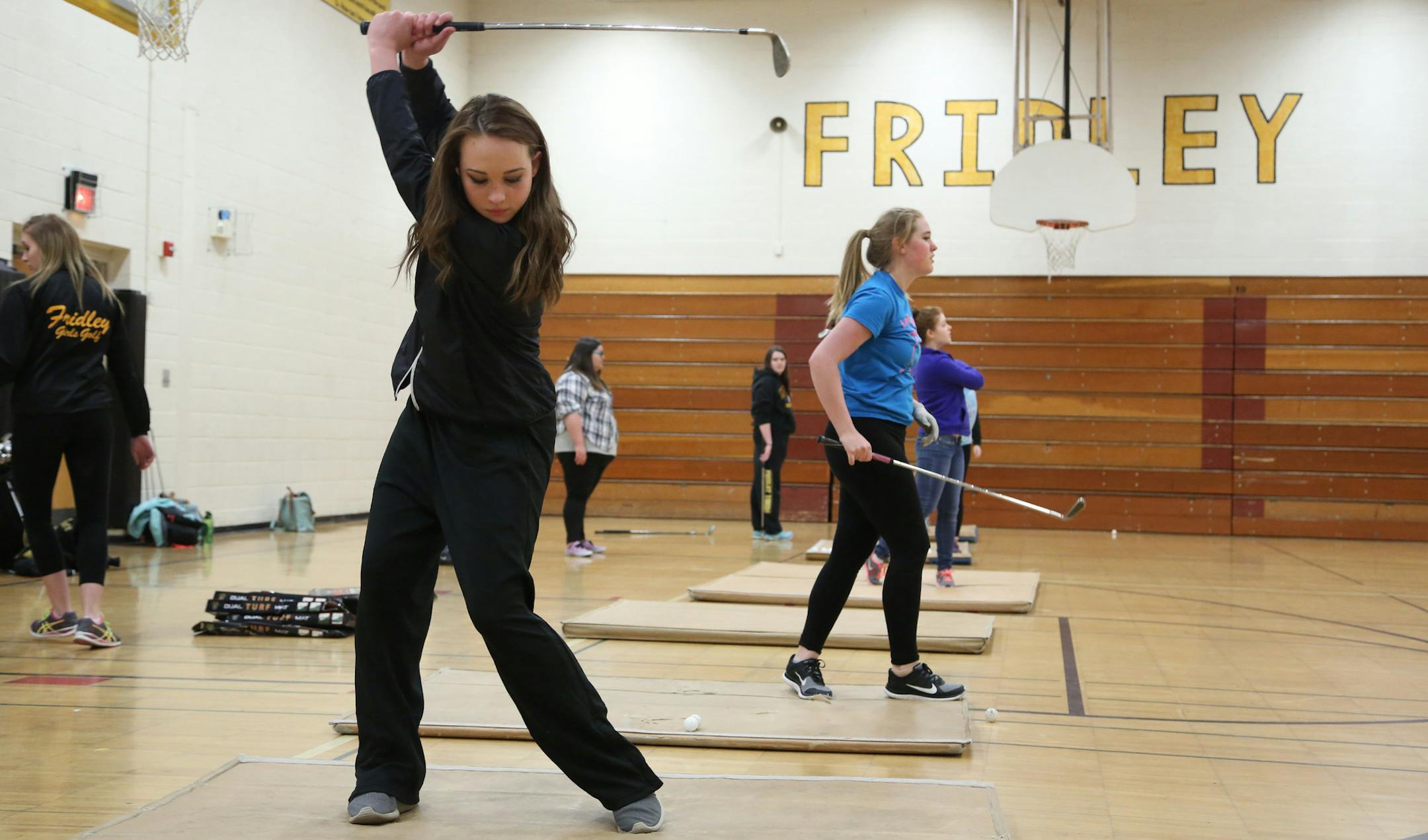 Brooke Teff, left and Christina Collins hit whiffle ball in the gym during practice. ] (KYNDELL HARKNESS/STAR TRIBUNE) kyndell.harkness@startribune.com Fridley girls golf practice inFridley Min., Saturday, March19, 2015