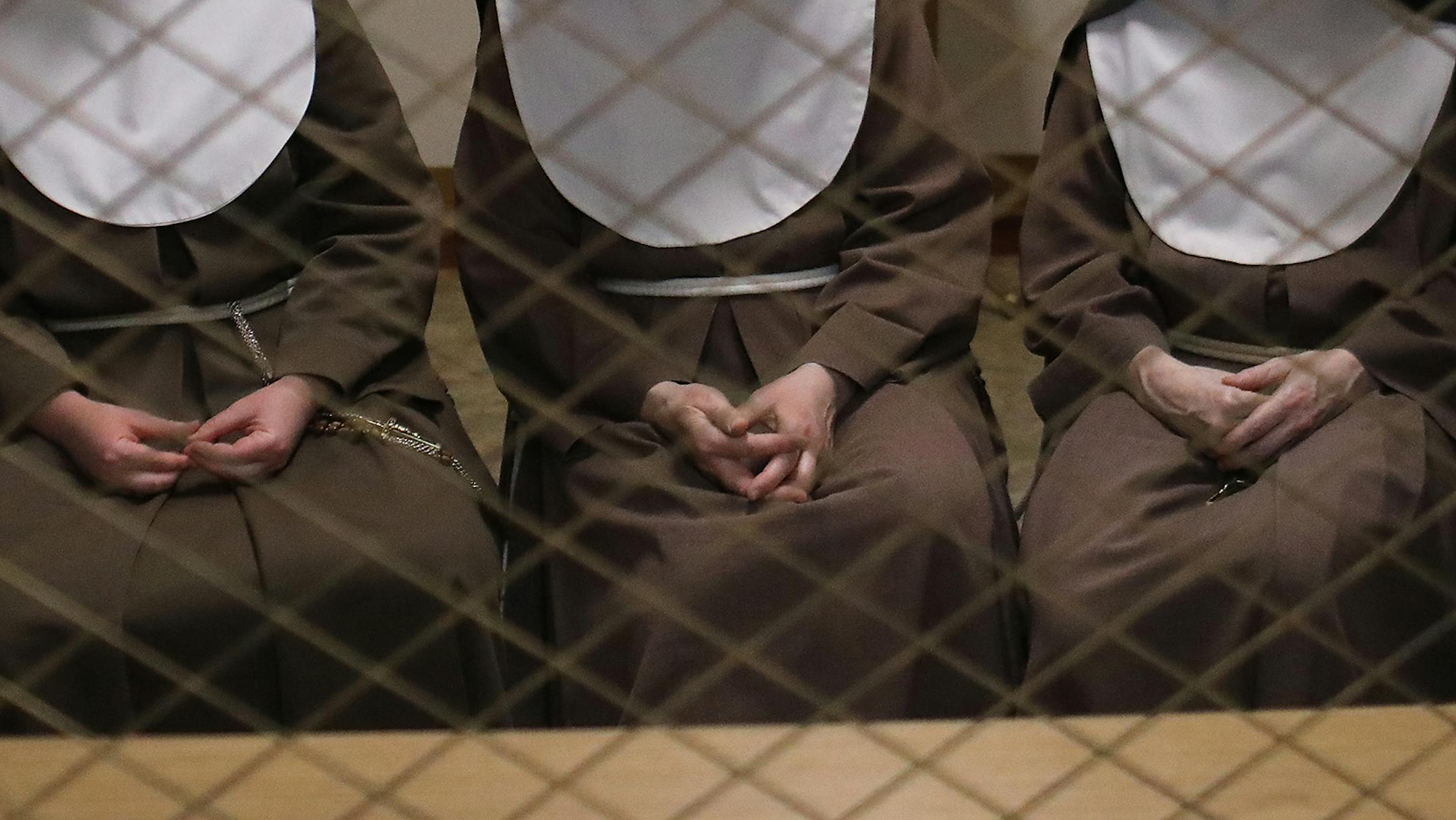 Poor Clare nuns of St. Clare's Monastery nuns met with journalists in the monastery's parlor, the one room where outsiders have partial access to the nuns in a room divided by a metal fencing with a folding wooden divider and seen Thursday, April 16, 2020, in Sauk Rapids, MN. Pictured are nuns Sister Mary Christiana, left to right, Sister Mary Matthew and Sister Marie Elizabeth.