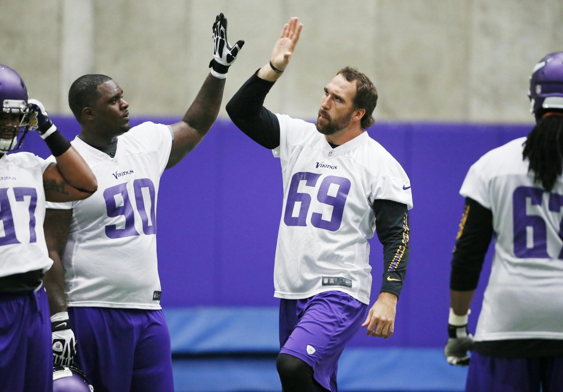 Vikings Fred Evans gave Jared Allen a high five during Minnesota Vikings OTA practice Wednesday June, 5 2013 in Eden Prairie, MN.