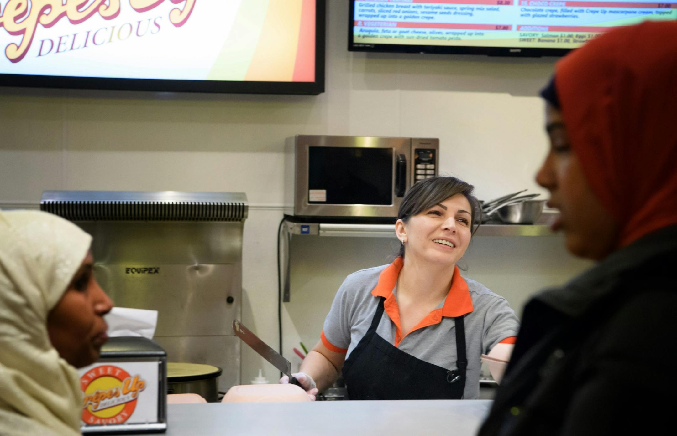 Owner and former student Oksana Goldenstein busily made fresh crepes for the thirty students and staff from her former school.