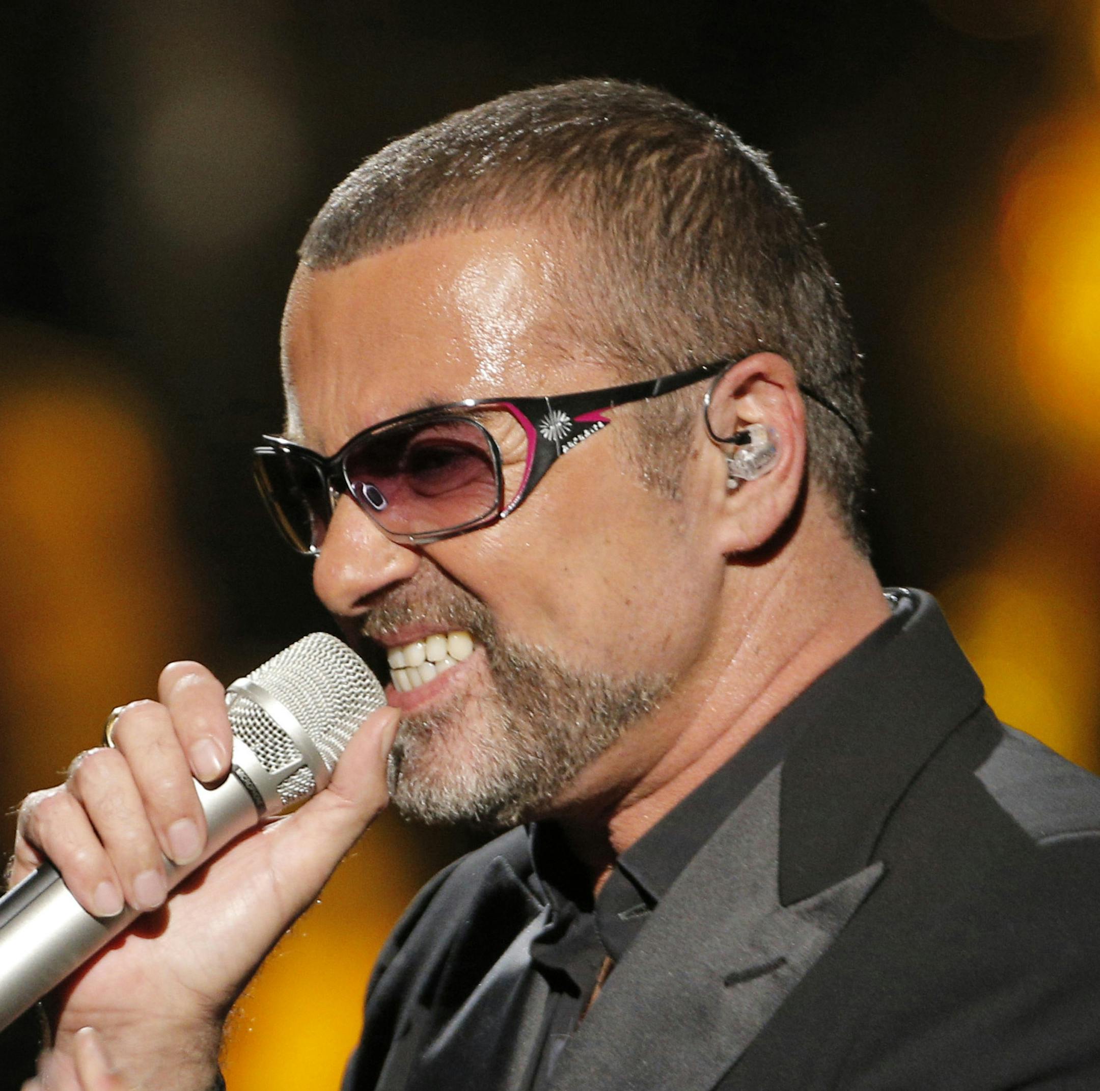 FILE - In this Sept. 9, 2012 file photo, British singer George Michael sings in concert to raise money for AIDS charity Sidaction, in Paris, France. A British coroner said Tuesday, March 7, 2017, that George Michael died of natural causes as the result of heart disease and a fatty liver. Darren Salter, senior coroner for Oxfordshire, says a post-mortem has found that the singer died of "dilated cardiomyopathy with myocarditis and fatty liver." Michael died at his home in southern England, on Dec