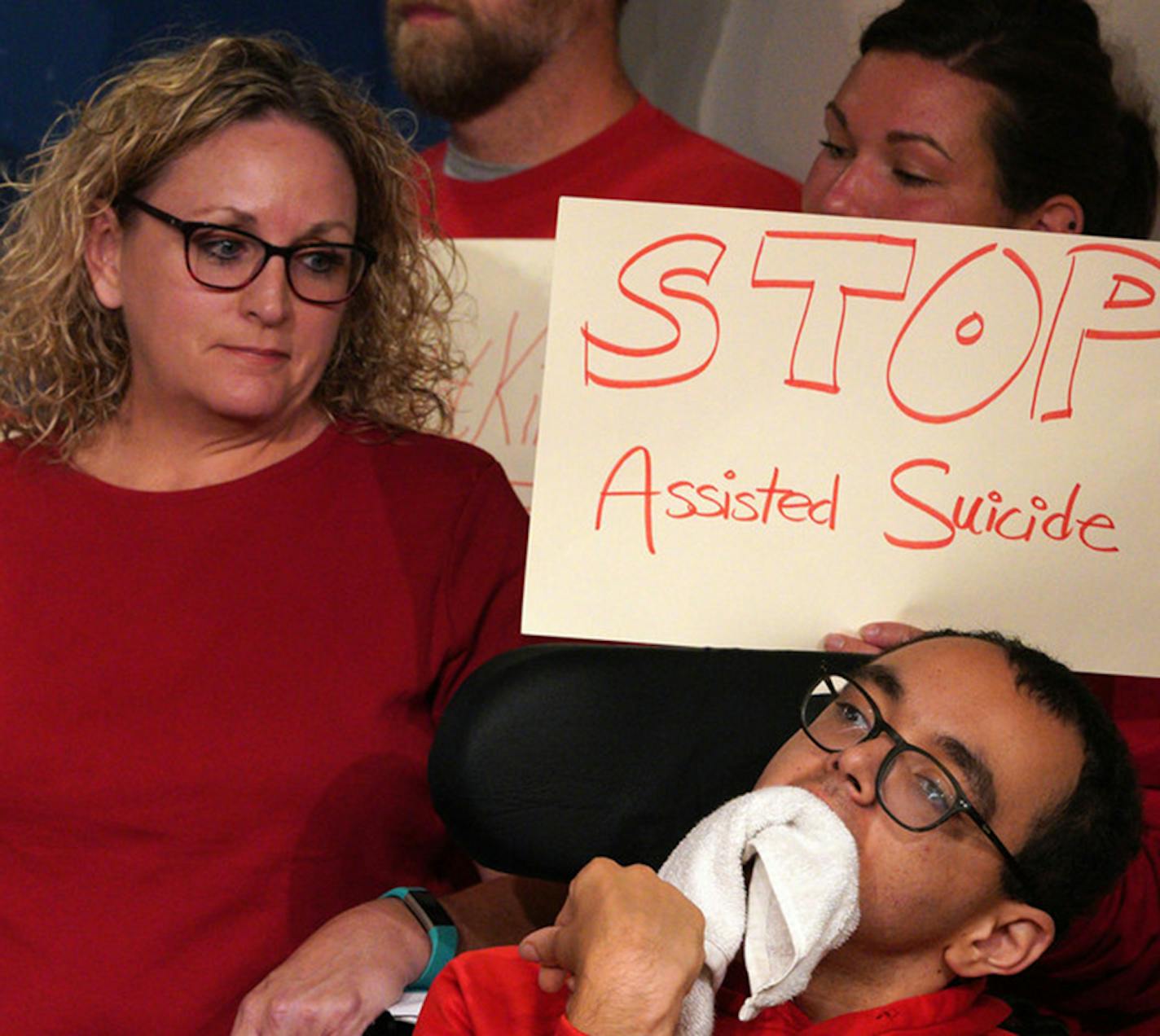 Kathy Ware, whose 25-year-old son Kylen, at right, has quadriplegic cerebral palsy and profound mental retardation, spoke at a news conference Wednesday against the proposal.