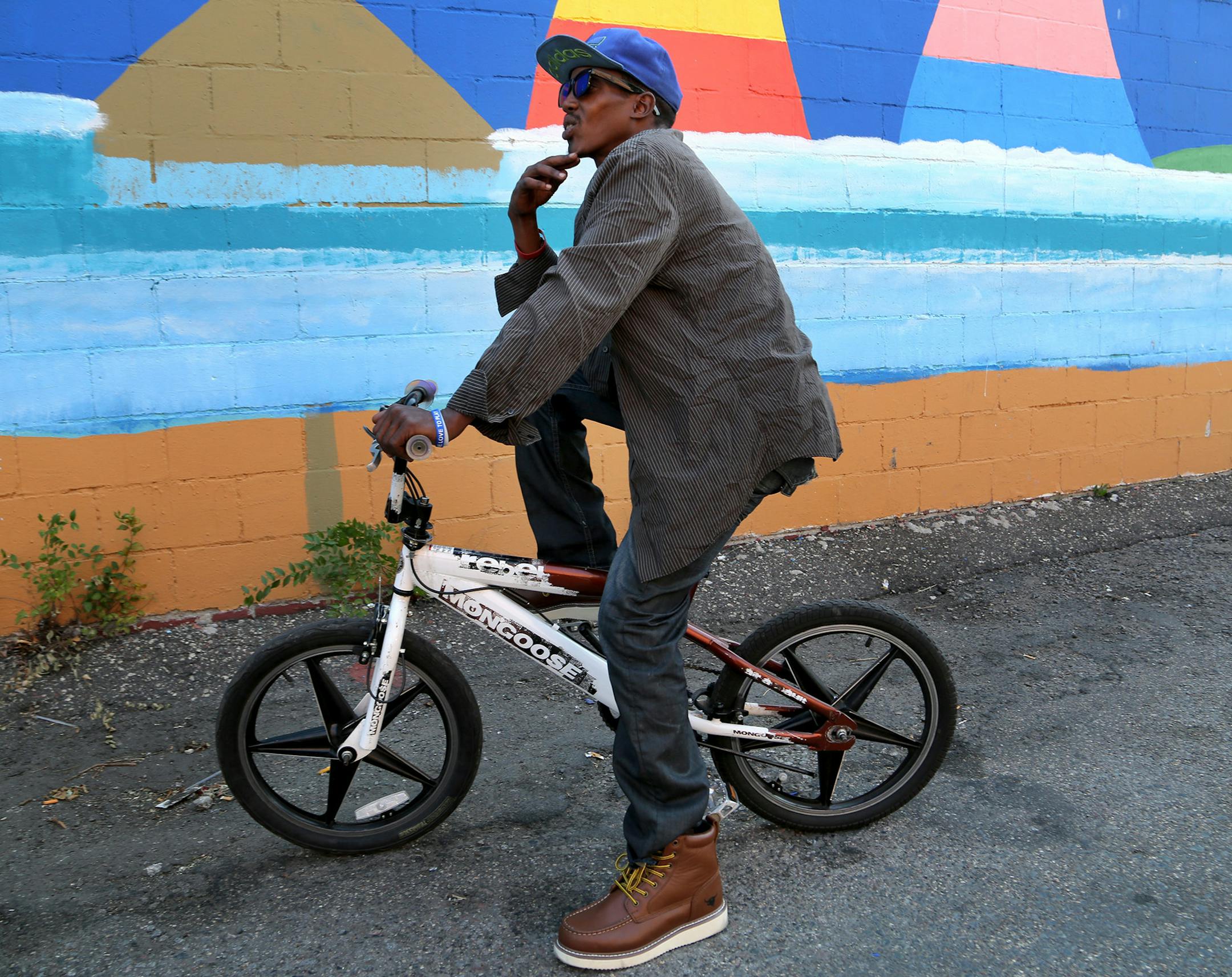 Abdi Rahim Abdi, 33, of Minneapolis showed off his Mongoose bike during an interview near Chicago Avenue on Sept. 13, 2017, in Minneapolis, MN. Abdi, who currently isnít working, said he rides everyday, sometimes for two hours at a time. ìI like the exercise.î Abdi said he sometimes rode a bike in his home country of Somalia and later when he lived in Kenya.] DAVID JOLES ï david.joles@startribune.com iCycle, an occasional biking series
