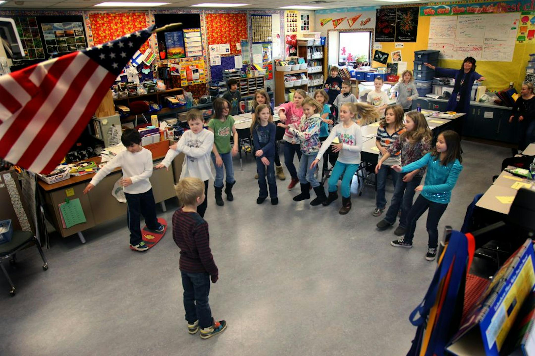 Akin Elementary third-graders are led through a series of exercises during physical exercise time between subjects, Wednesday, January 18, 2012.