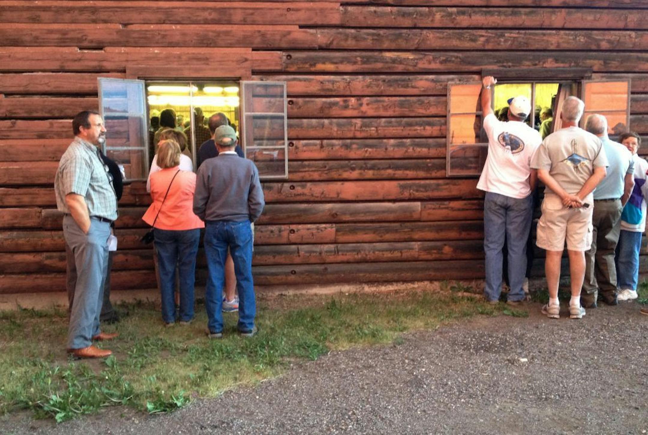In this Thursday, June 20, 2013 photo provided by the U.S. Forest Service, people attend a town meeting in South Fork, Colo. A massive wildfire was headed toward aSouth Fork on Friday, and fire managers rate the chances of saving it as slim if the fire continues its course. The town of about 400 people was evacuated Friday morning, June 21, 2013.