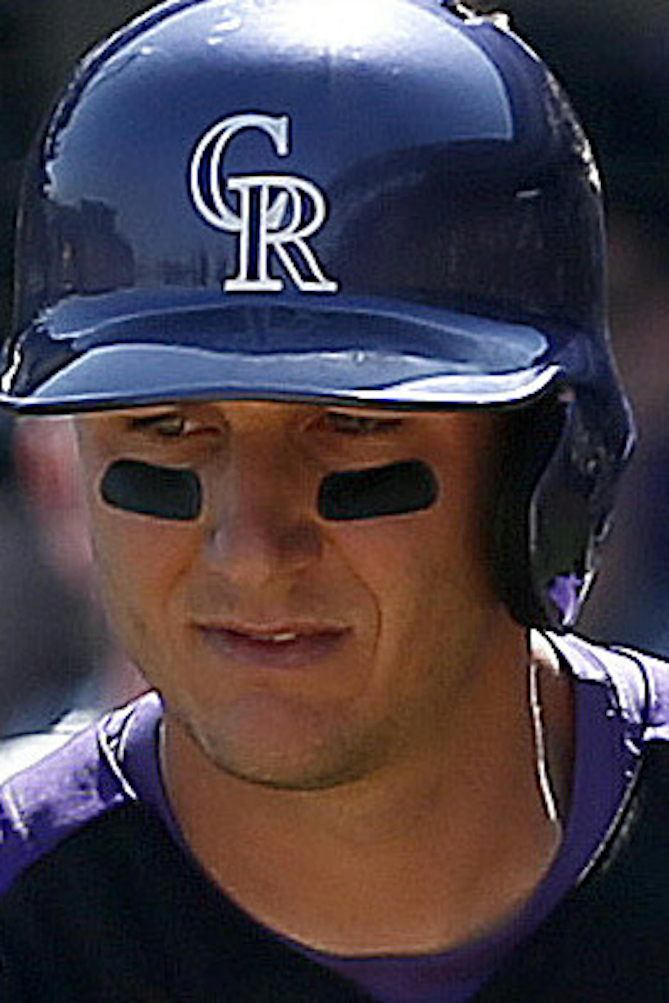 Colorado Rockies' Dexter Fowler (24) gets a handshake from teammate Troy Tulowitzki after Fowler scores a run against the San Francisco Giants during an MLB spring training baseball game, Friday, March 22, 2013, in Scottsdale, Ariz. (AP Photo/Ross D. Franklin)