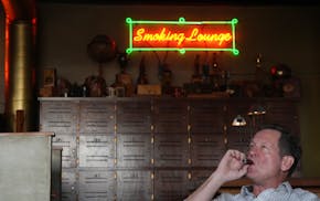 Joe Blauert, of St. Paul, enjoys a cigar in the smoking lounge at Anthony's Pipe and Cigar Lounge in south Minneapolis last November. The Minneapolis