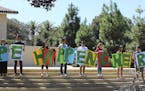 In this Sept. 16, 2015 photo provided by Tessa Ormenyi, students hold up a sign about rape at White Plaza during New Student Orientation on the Stanfo