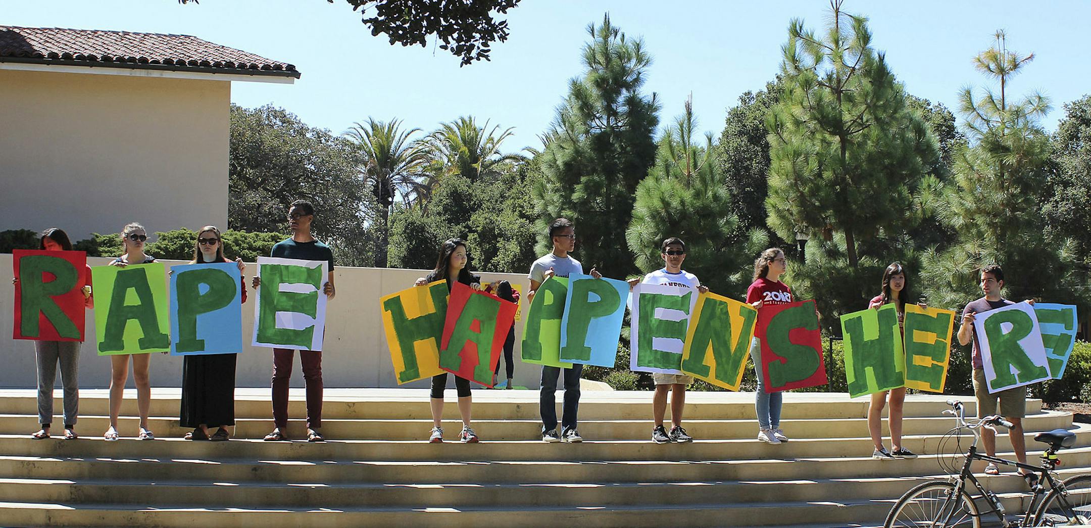 In this Sept. 16, 2015 photo provided by Tessa Ormenyi, students hold up a sign about rape at White Plaza during New Student Orientation on the Stanford University campus in Stanford, Calif. Stanford University considers itself a national leader on preventing and handling sexual assaults, but students have complained that the school isn't doing enough and have drawn attention to the issue by holding demonstrations. (Tessa Ormenyi via AP) MANDATORY CREDIT ORG XMIT: FX105