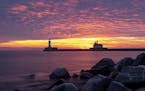 The first sunrise of 2020 brought deep orange and pink colors over the Duluth Harbor North and South Breakwater Lighthouses in Duluth