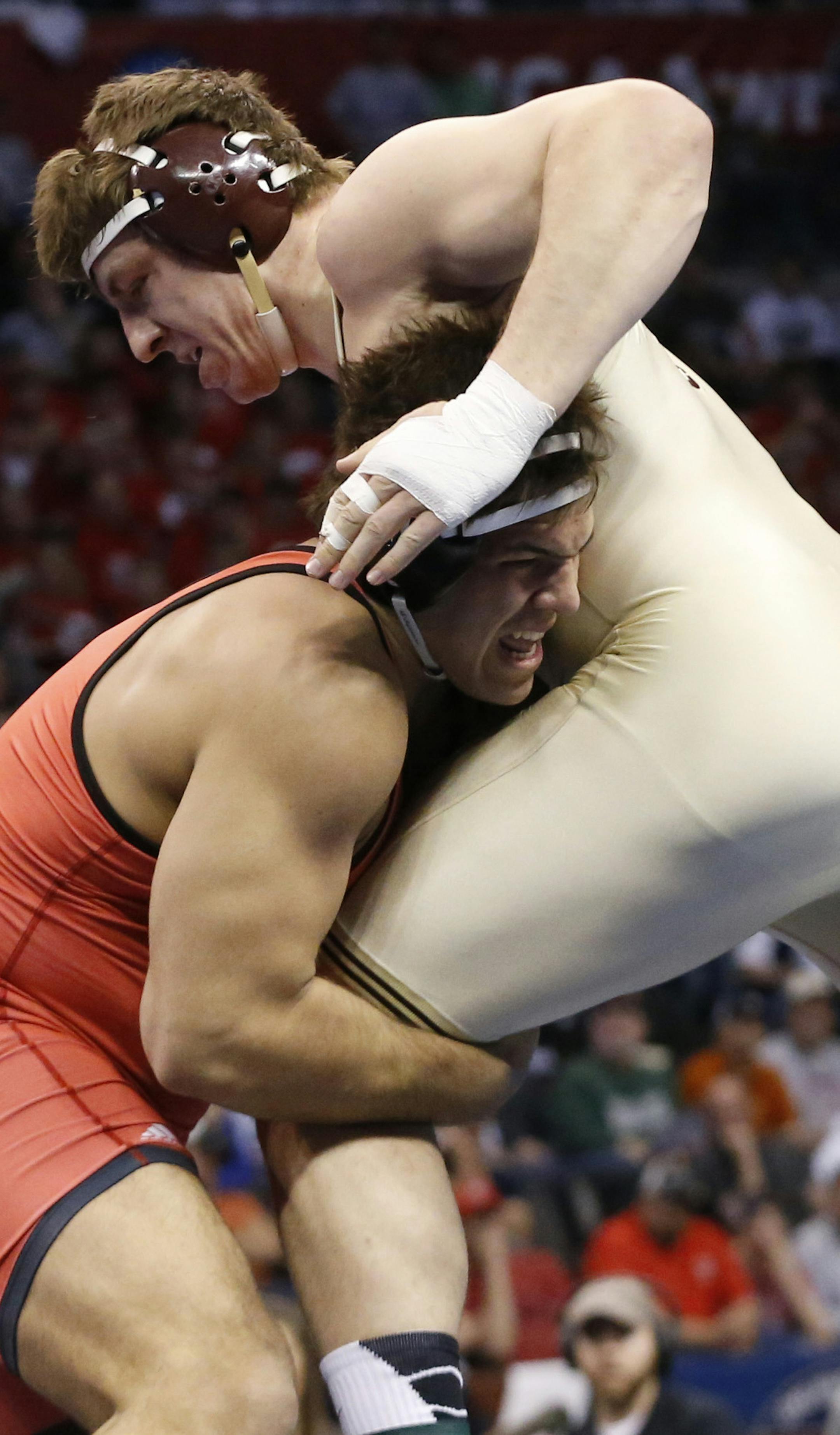 Minnesota's Anthony Nelson, right, works against North Carolina State's Nick Gwiazdowski, left, in the 285-pound match in the finals of the NCAA Division I wrestling championships in Oklahoma City, Saturday, March 22, 2014. Gwiazdowski won the title. (AP Photo/Sue Ogrocki)