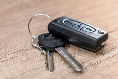 black car key on wooden desk with copy space