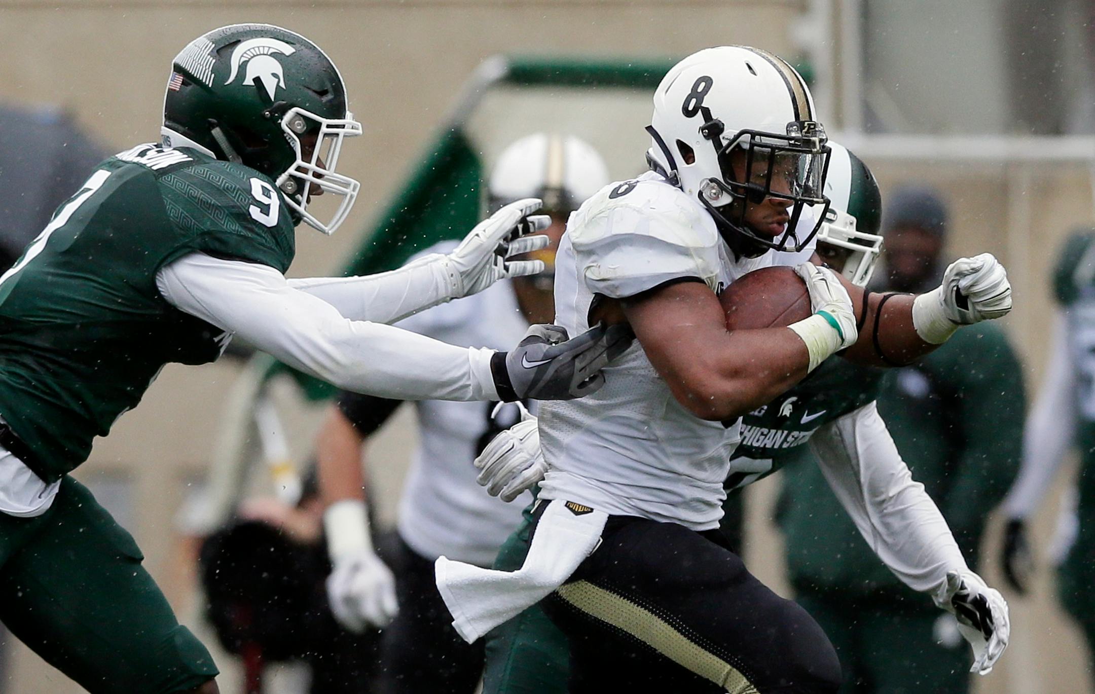 Purdue running back Markell Jones (8) pulled away from Michigan State safety Montae Nicholson (9) and cornerback Darian Hicks for a 68-yard touchdown run during the second half last Saturday.