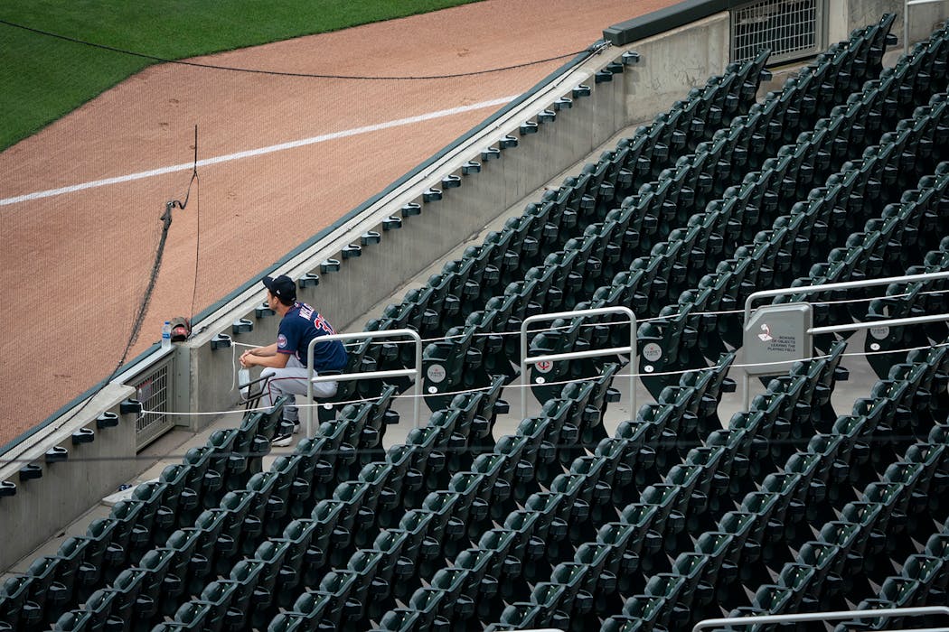 Relief pitcher Matt Wisler (37) sat in the empty stands during the scrimmage before his stint on the mound,