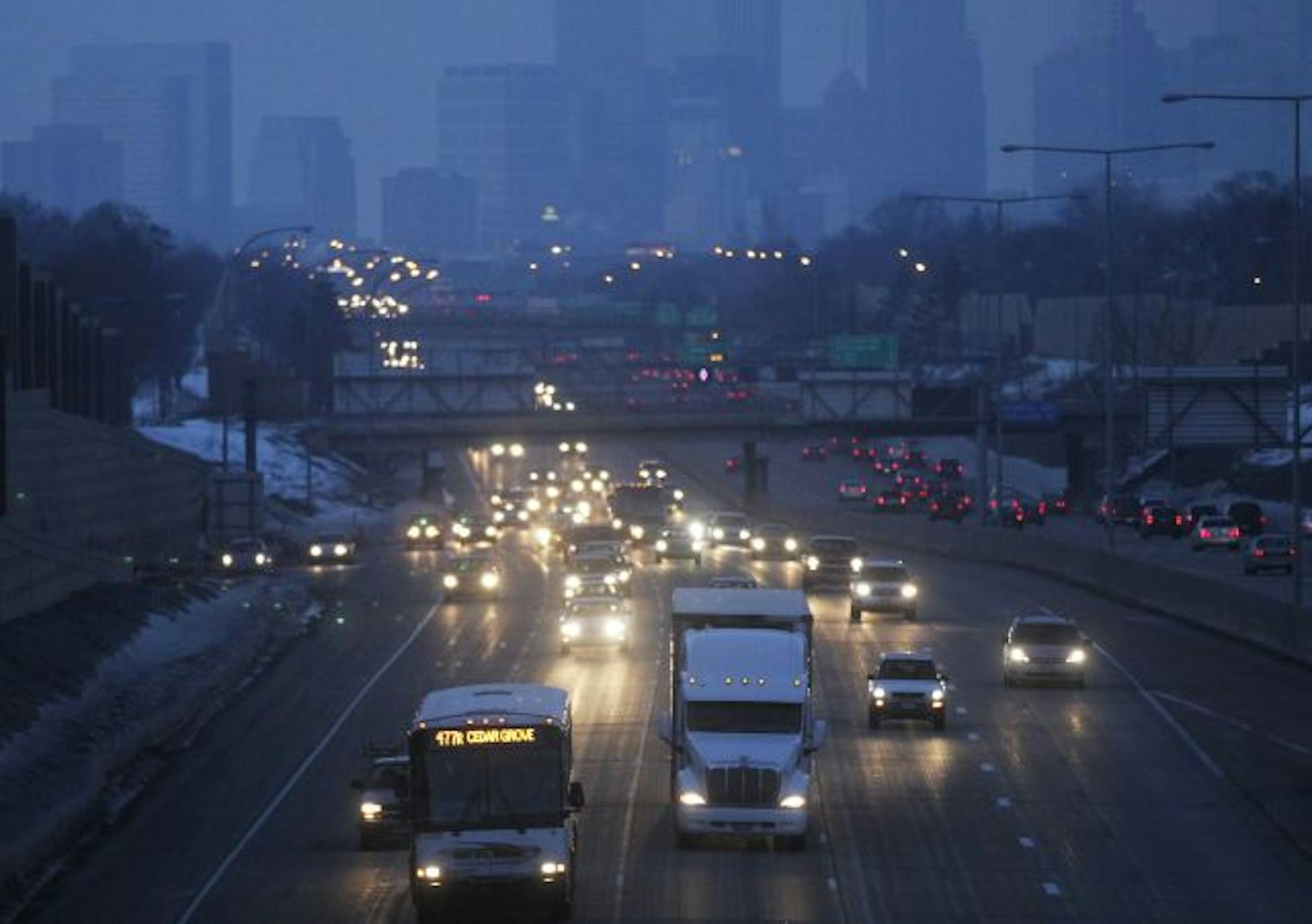 At new BRT station on 46th street overlooking 35W, a bus heads South during rush hour.
