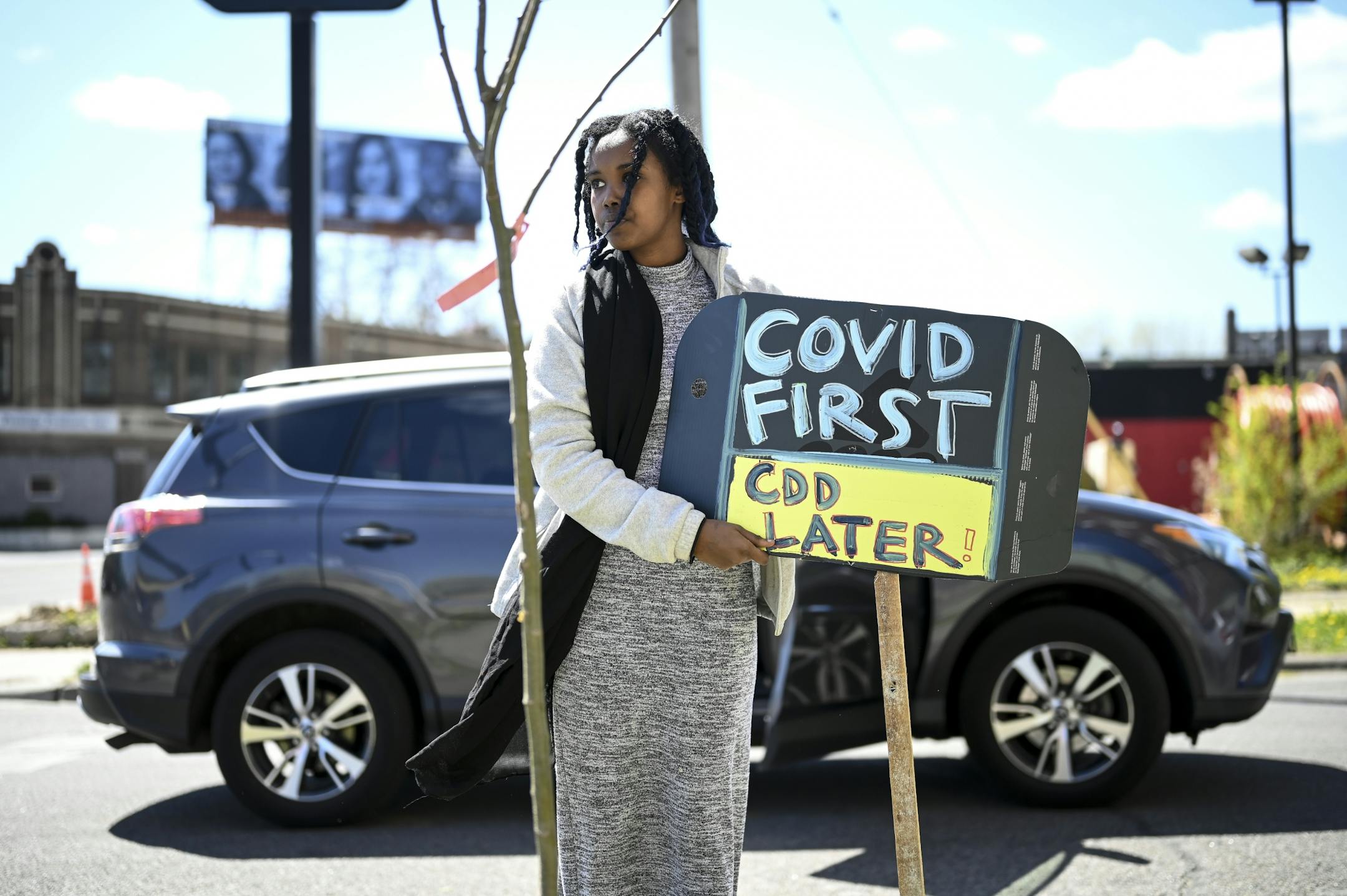 Samiya Noor, a student at Patrick Henry, put up an anti-CDD sign outside the Minneapolis Public School headquarters Friday.