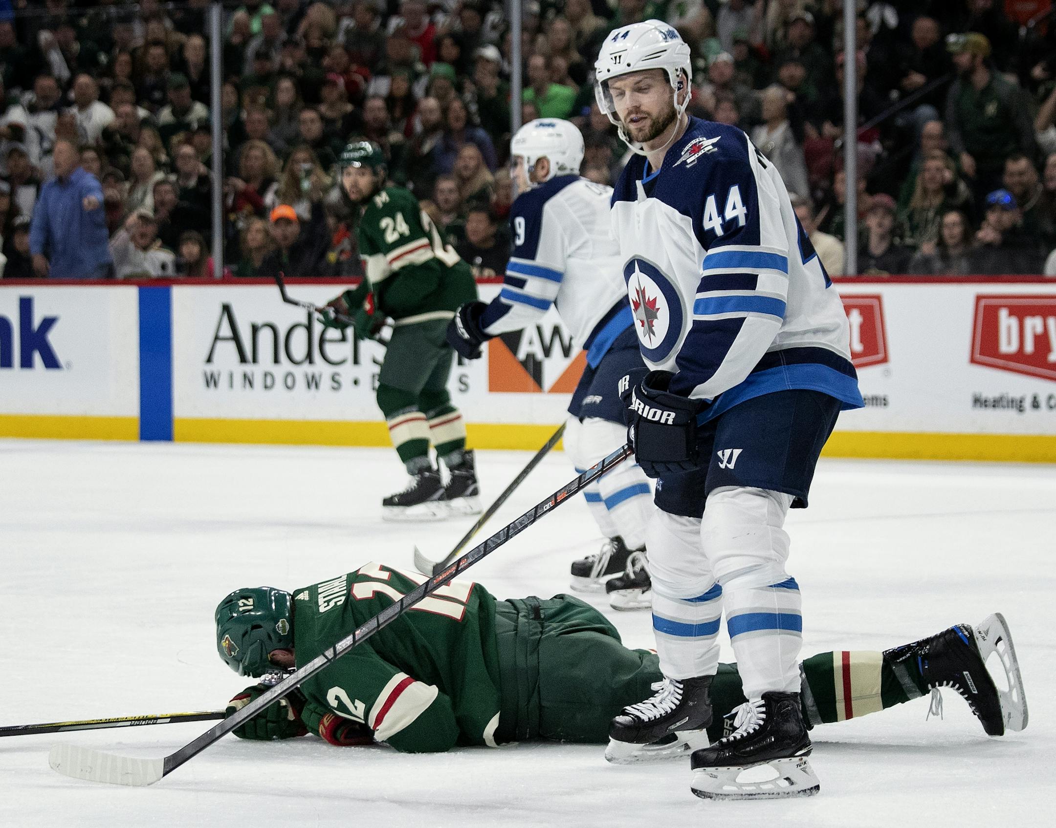 Josh Morrissey (44) and Eric Staal (12) in the first period.