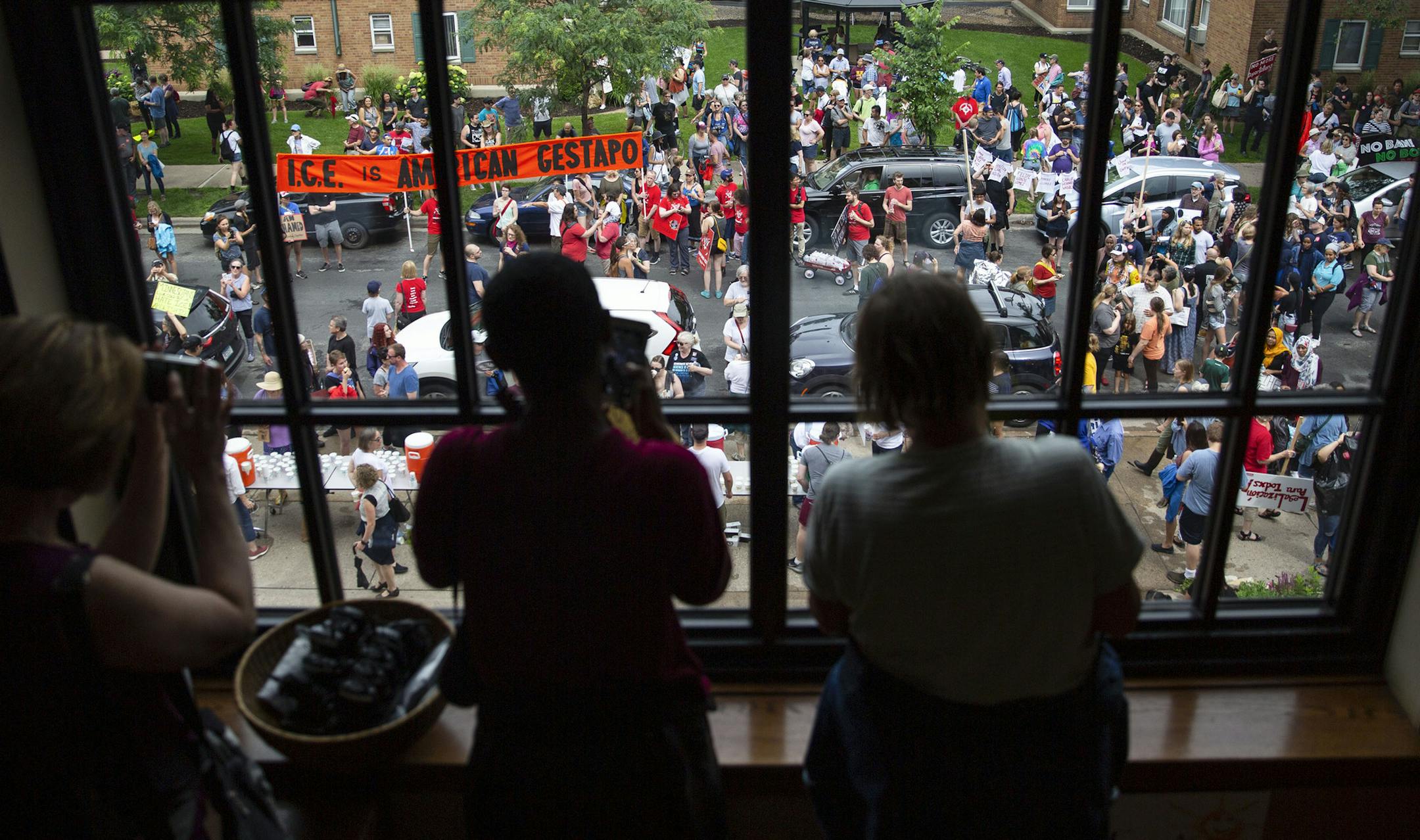 Protesters watched the tail end of the march as people gathered at the First Universalist Church of Minneapolis on Sunday.