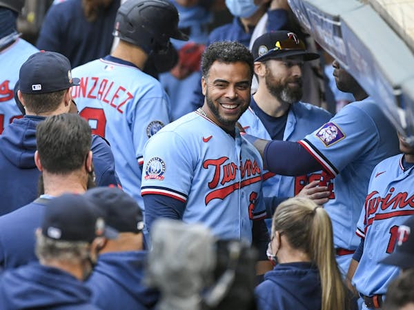 Minnesota Twins Minnesota Twins Nelson Cruz, center, smiles in the dugout after the Twins clinched the AL Central championship with the Chicago White 
