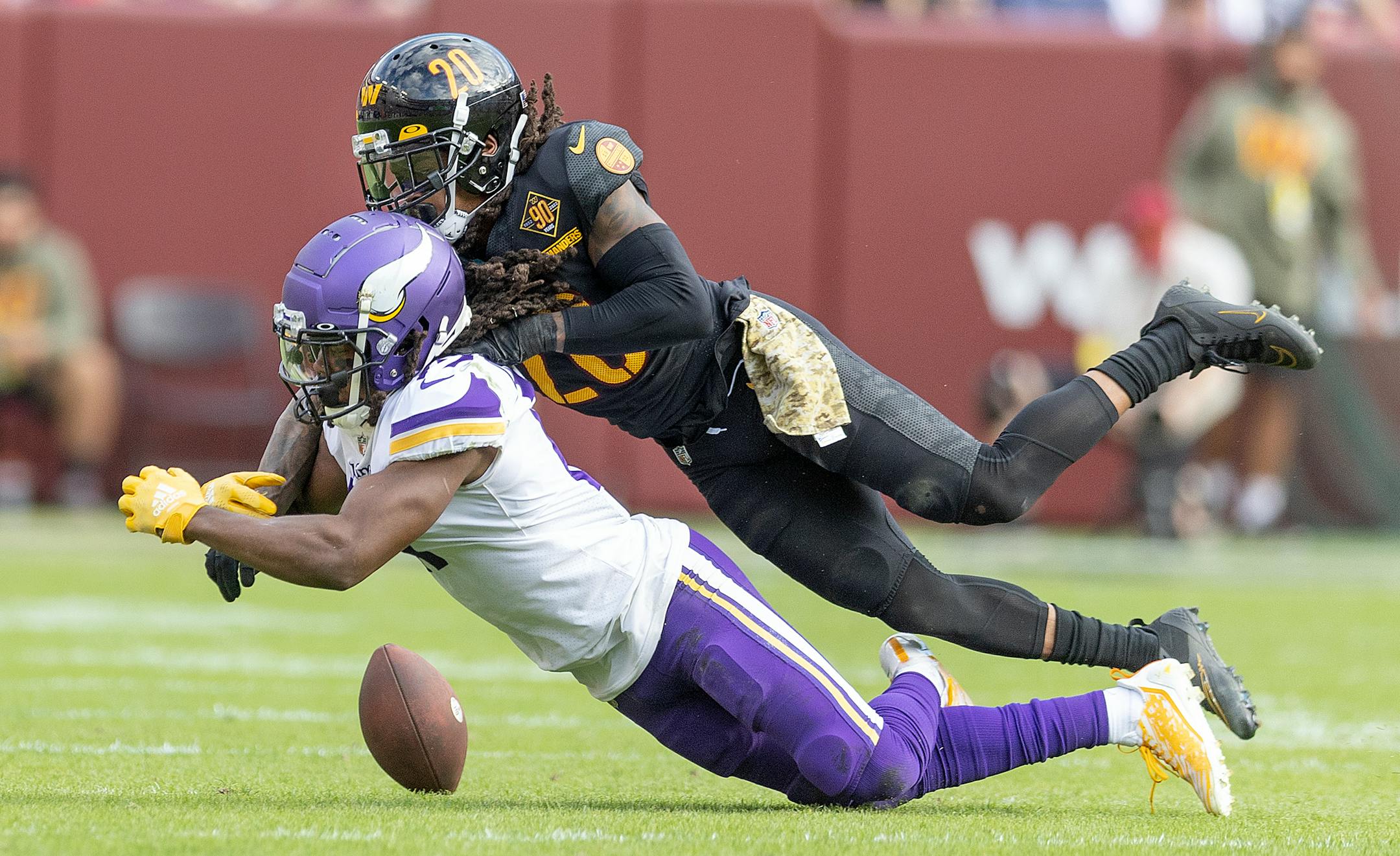 Washington Commanders safety Bobby McCain (20) breaks up a pass intended for Minnesota Vikings wide receiver K.J. Osborn (17)  in the third quarter.