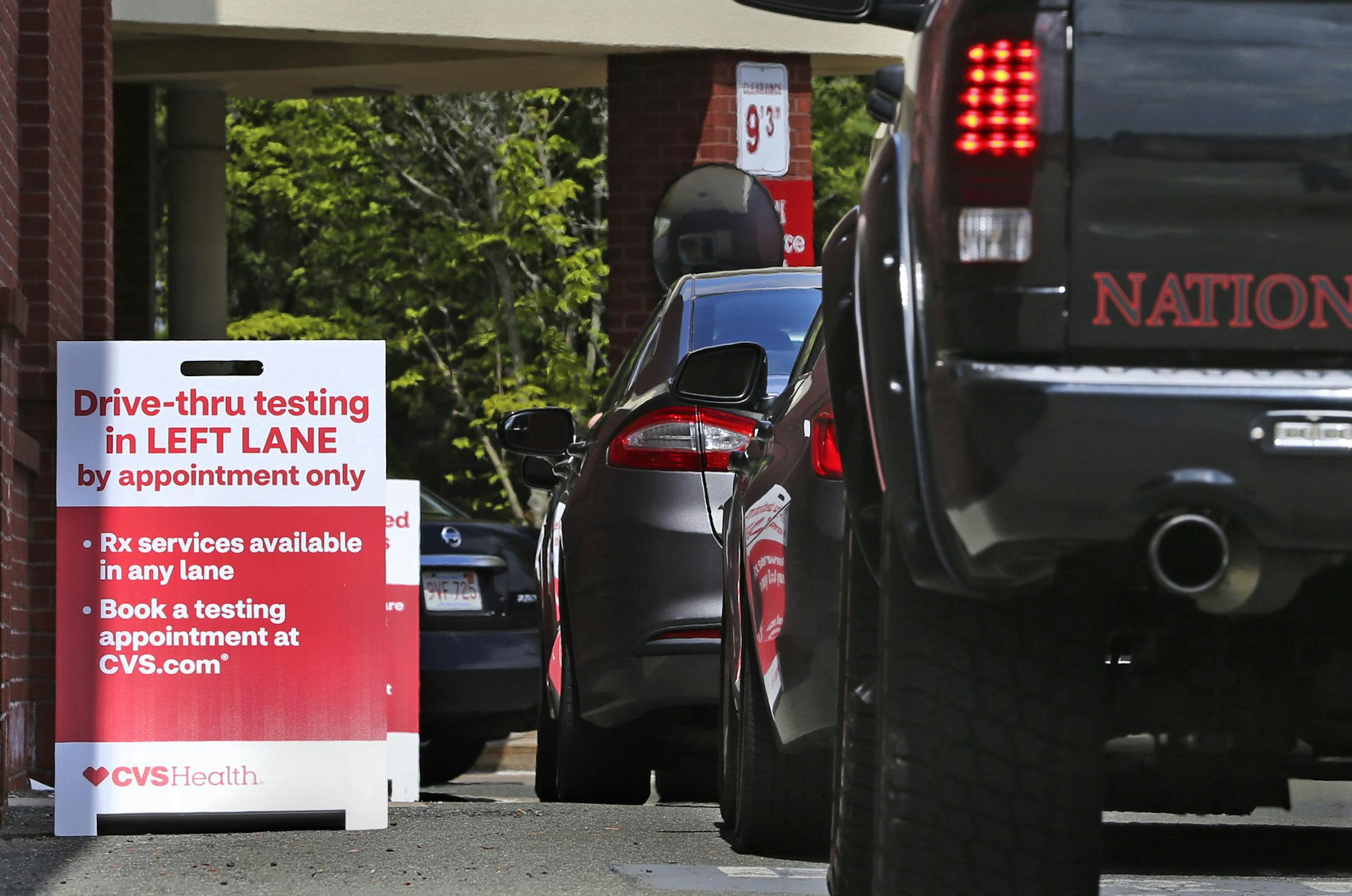 Cars idle in line as patients wait to self-take a COVID-19 virus test at a drive thru for the CVS Pharmacy in Danvers, Mass., Friday, May 15, 2020. CVS has expanded their testing sites. (AP Photo/Charles Krupa)