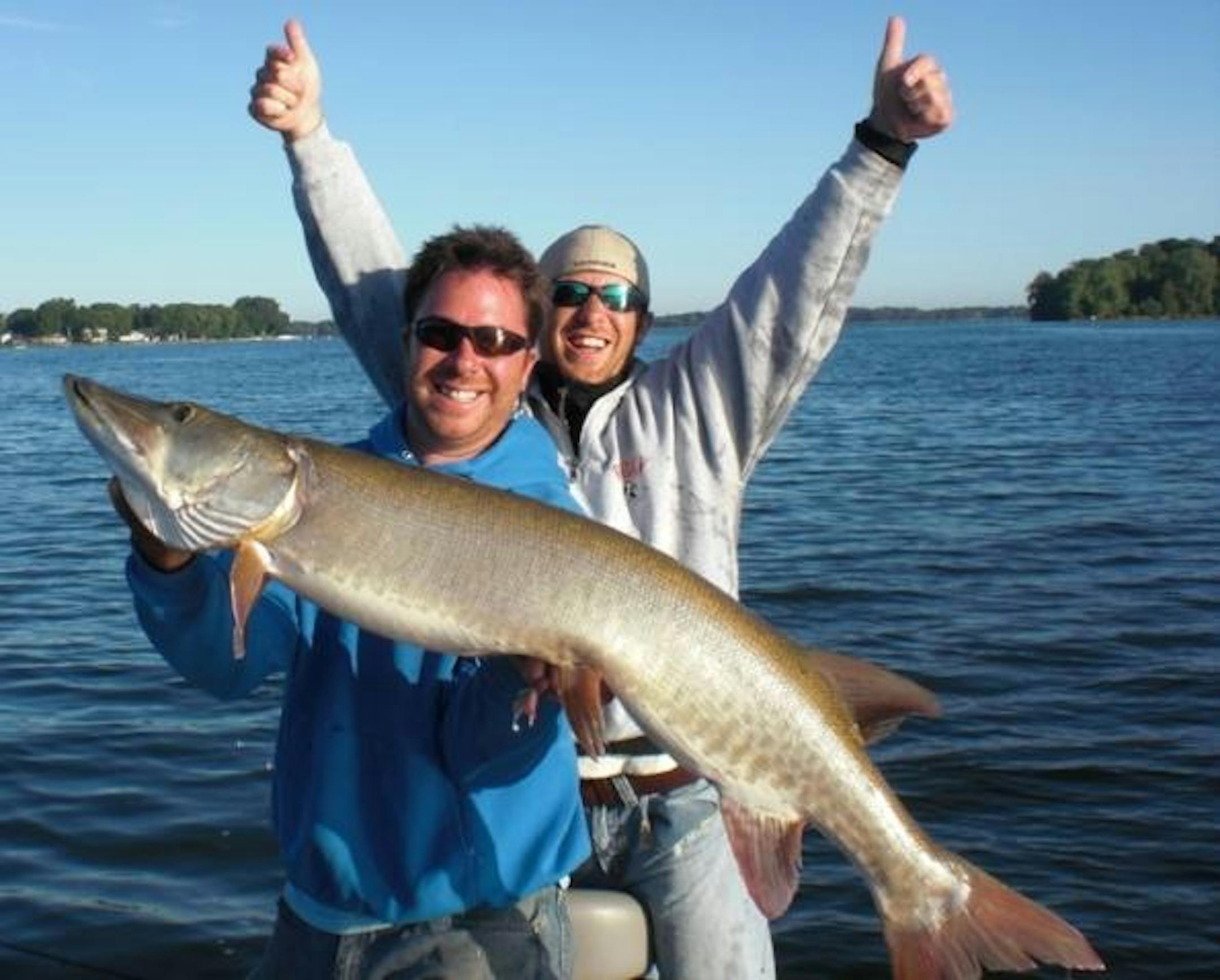 The author Travis Frank and his guest Mike Ernst holding a 50 incher caught on a metro lake on August 22nd.