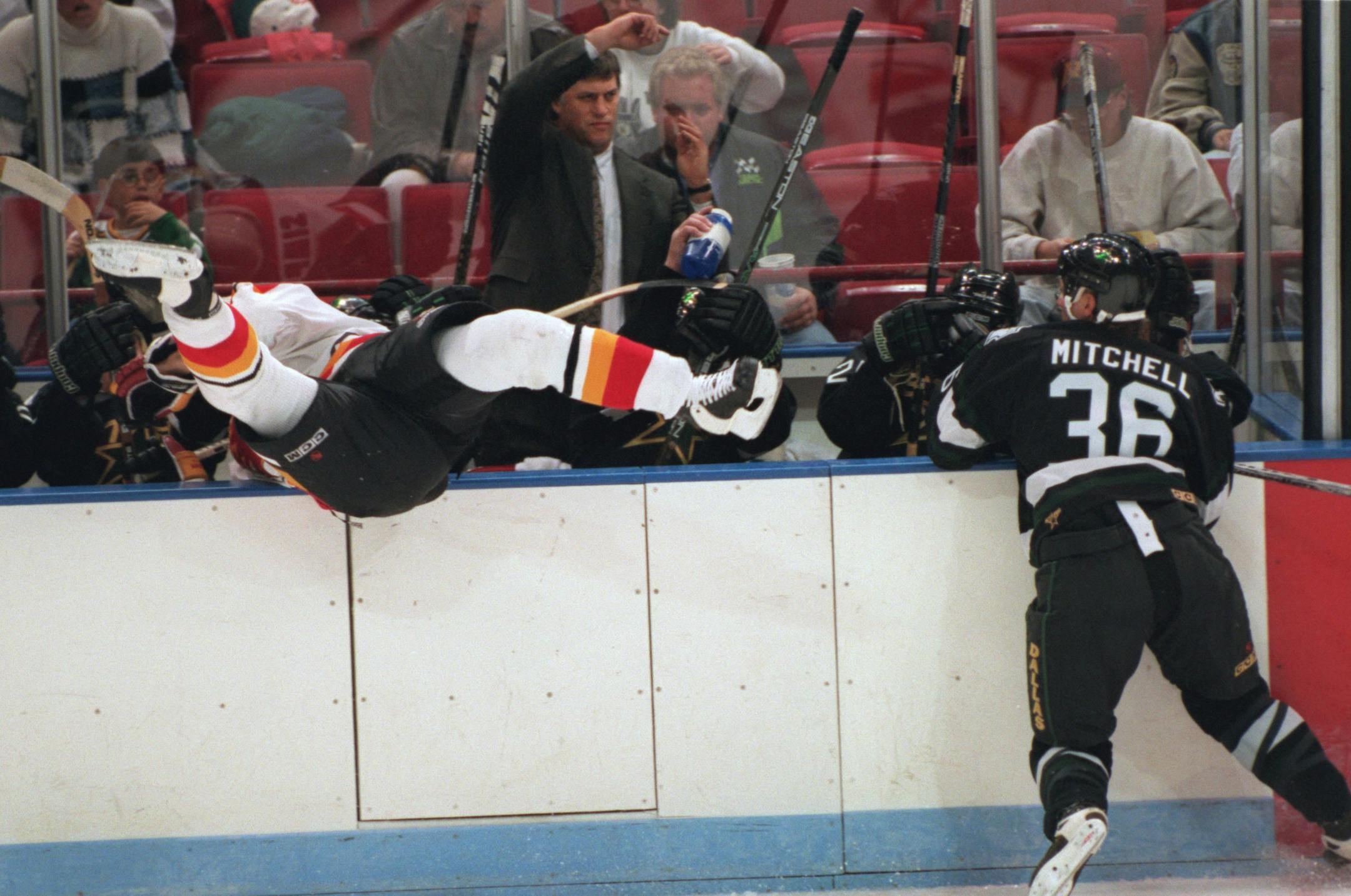 Jeff Mitchell, sent Flames defenseman Todd Simpson into the Stars bench at Target Center.