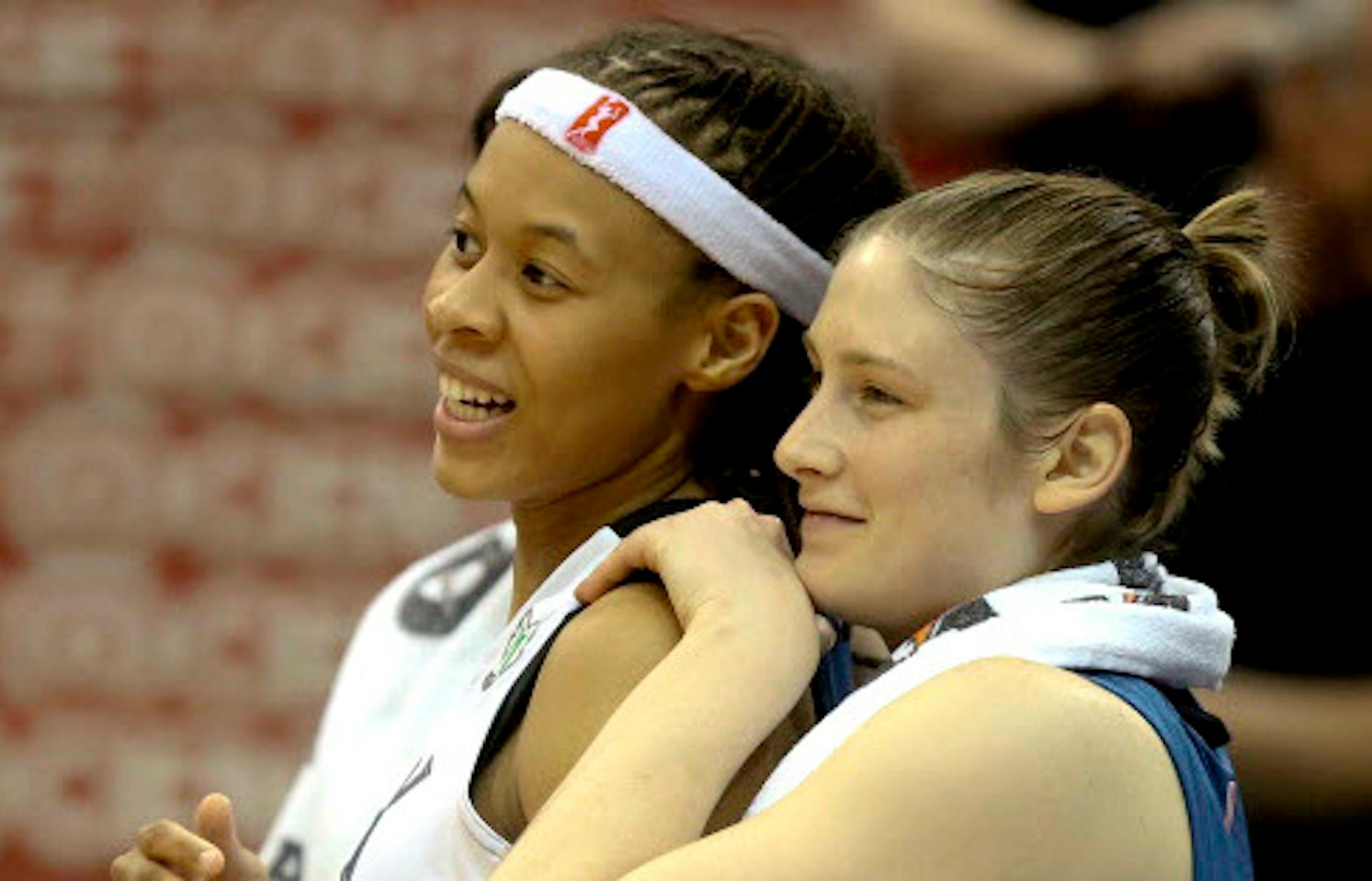 Lynx Seimone Augustus and Lindsay Whalen celebrates on the bench