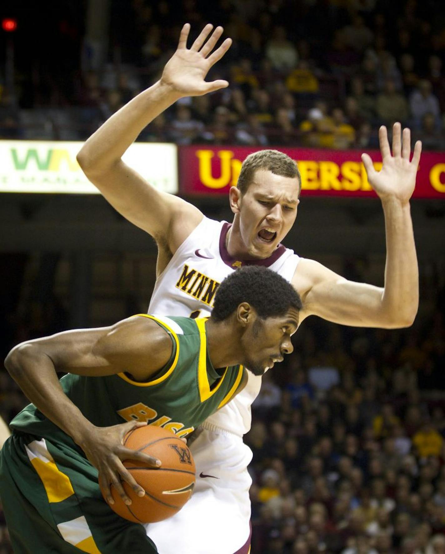 Minnesota's Oto Osenieks yells to distract North Dakota State's TrayVonn Wright in the first half at Williams Arena in Minneapolis, Minnesota, on Thursday, December 22, 2011. Minnesota pulled out a 63-59 victory.