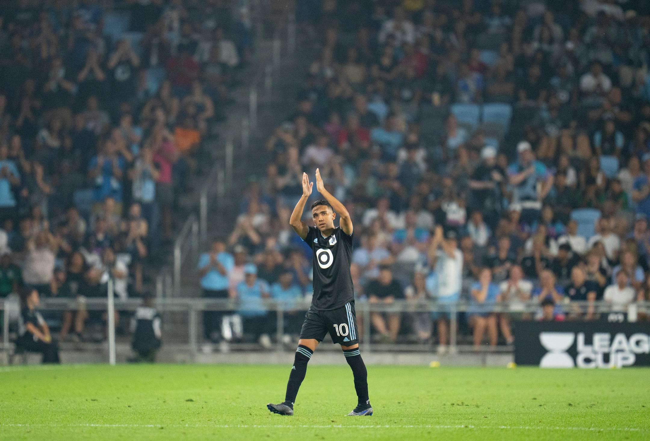 Minnesota United midfielder Emanuel Reynoso applauds the crowd as he is substituted out against Puebla in the second half of a Leagues Cup match Sunday night.