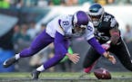 Vikings quarterback Sam Bradford scrambles to regain control of the ball after being hit hard by Eagles Brandon Graham in the 4th quarter.