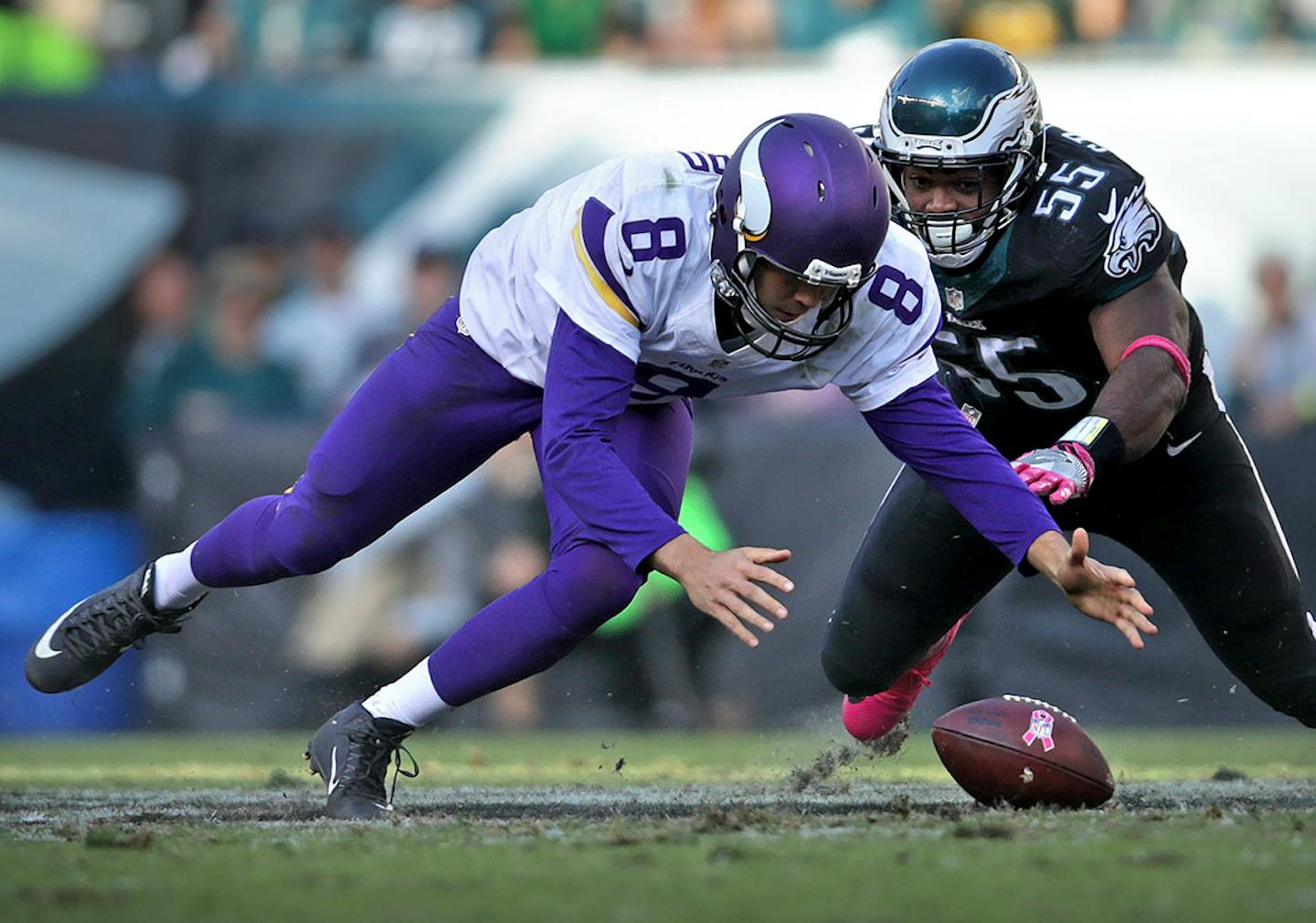 Vikings quarterback Sam Bradford scrambles to regain control of the ball after being hit hard by Eagles Brandon Graham in the 4th quarter.