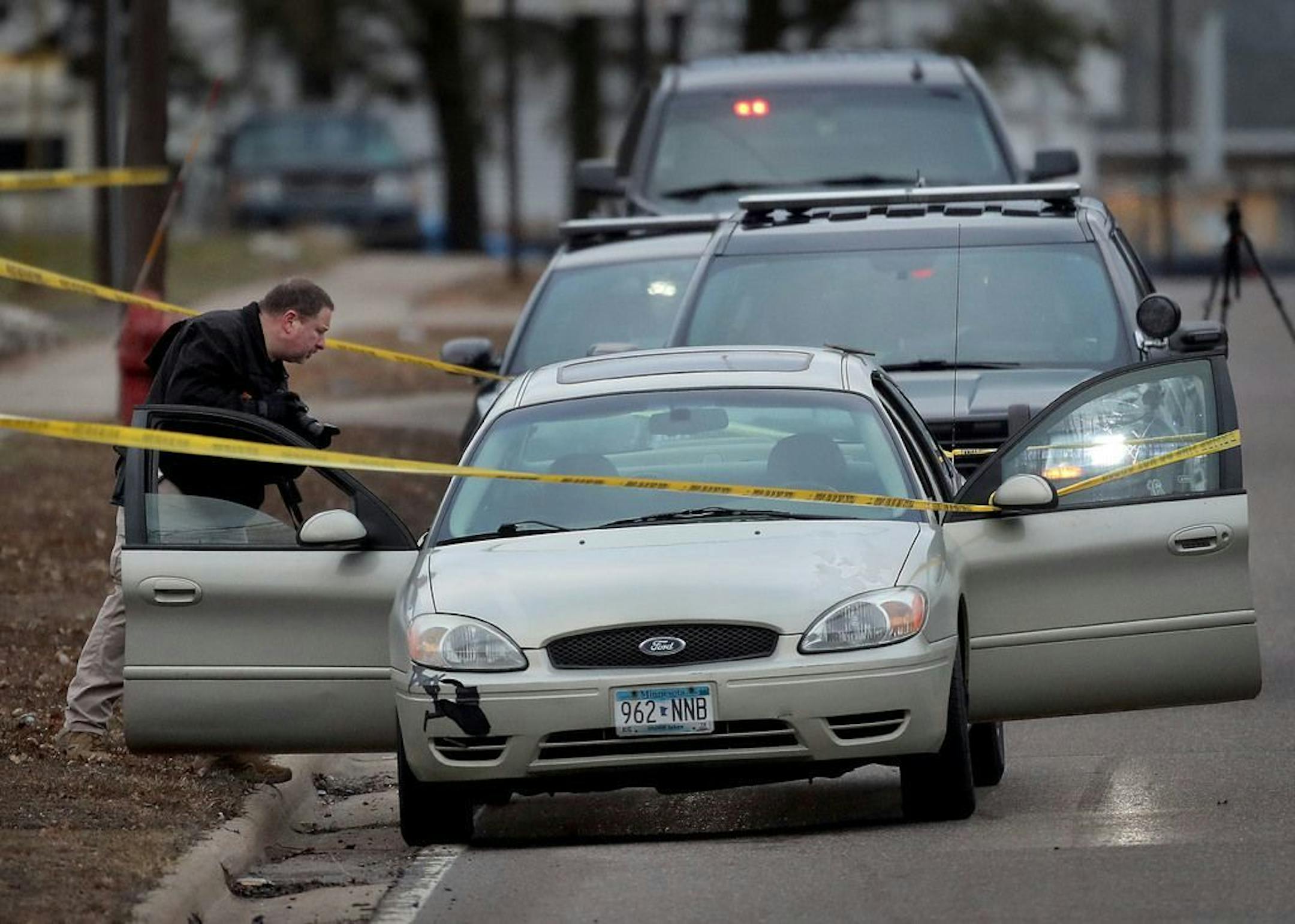 A BCA investigator photographs the scene of an officer-involved shooting near the 9900 block of Foley Blvd., Thursday in Coon Rapids.