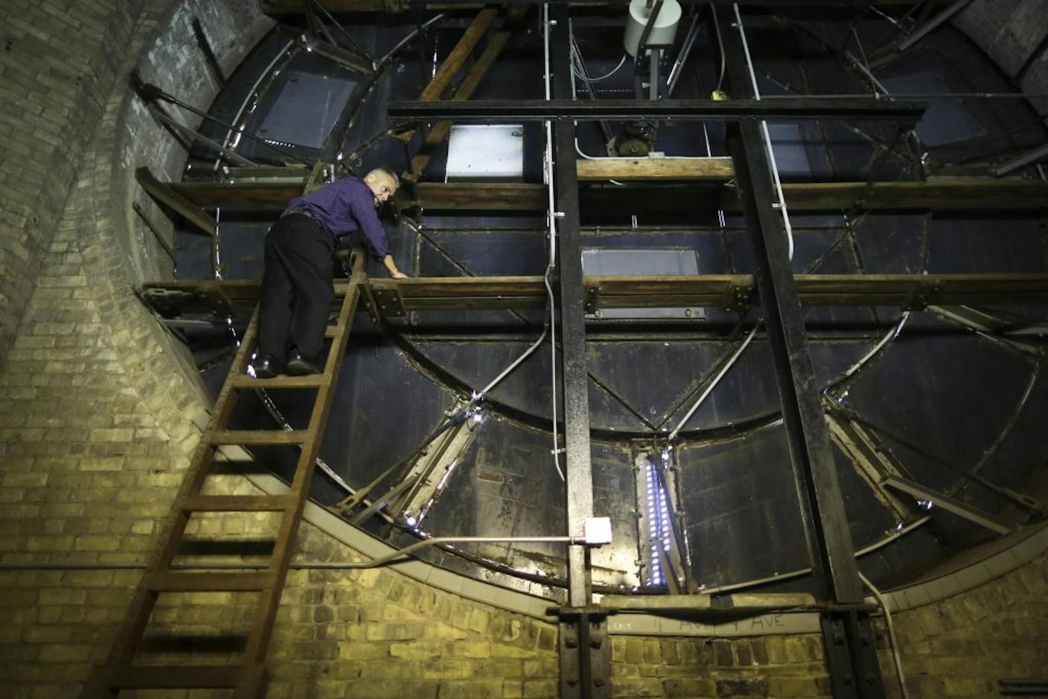 José Cervantes, director of the Municipal Building Commission, pointed out the damaged areas on the clock in Minneapolis' City Hall tower.