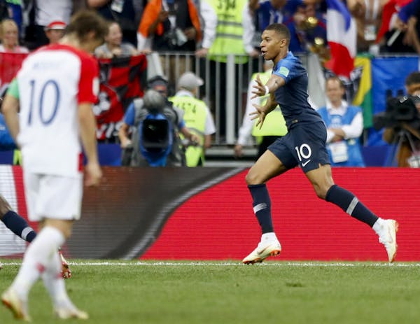 France's Kylian Mbappe celebrates after scoring his side's fourth goal during the final match between France and Croatia at the 2018 soccer World Cup 