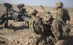 This June 10, 2017 photo provided by Operation Resolute Support, U.S. Soldiers with Task Force Iron maneuver an M-777 howitzer, so it can be towed int