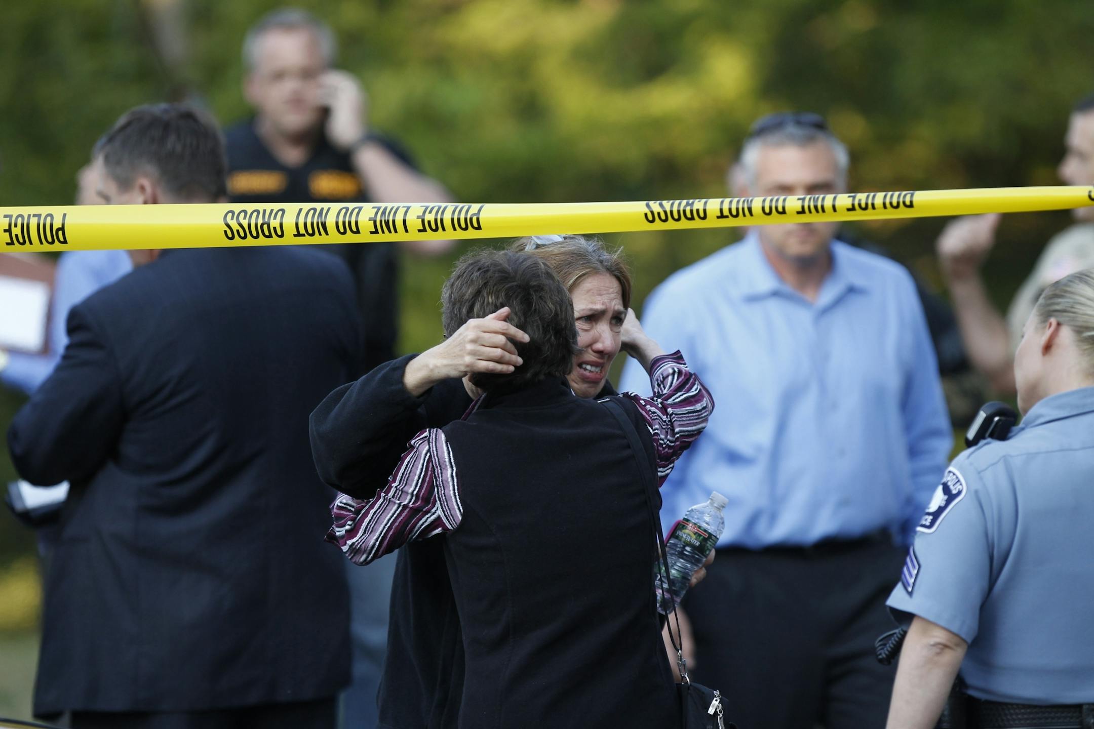 Shereen Rahamim was consoled Thursday after a workplace shooting left several people dead, including her husband Reuven Rahamim, the company's founder.
