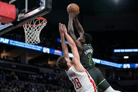 Minnesota Timberwolves guard Anthony Edwards (1) dunks against Houston Rockets center Alperen Sengun (28) during the first half of an NBA basketball g
