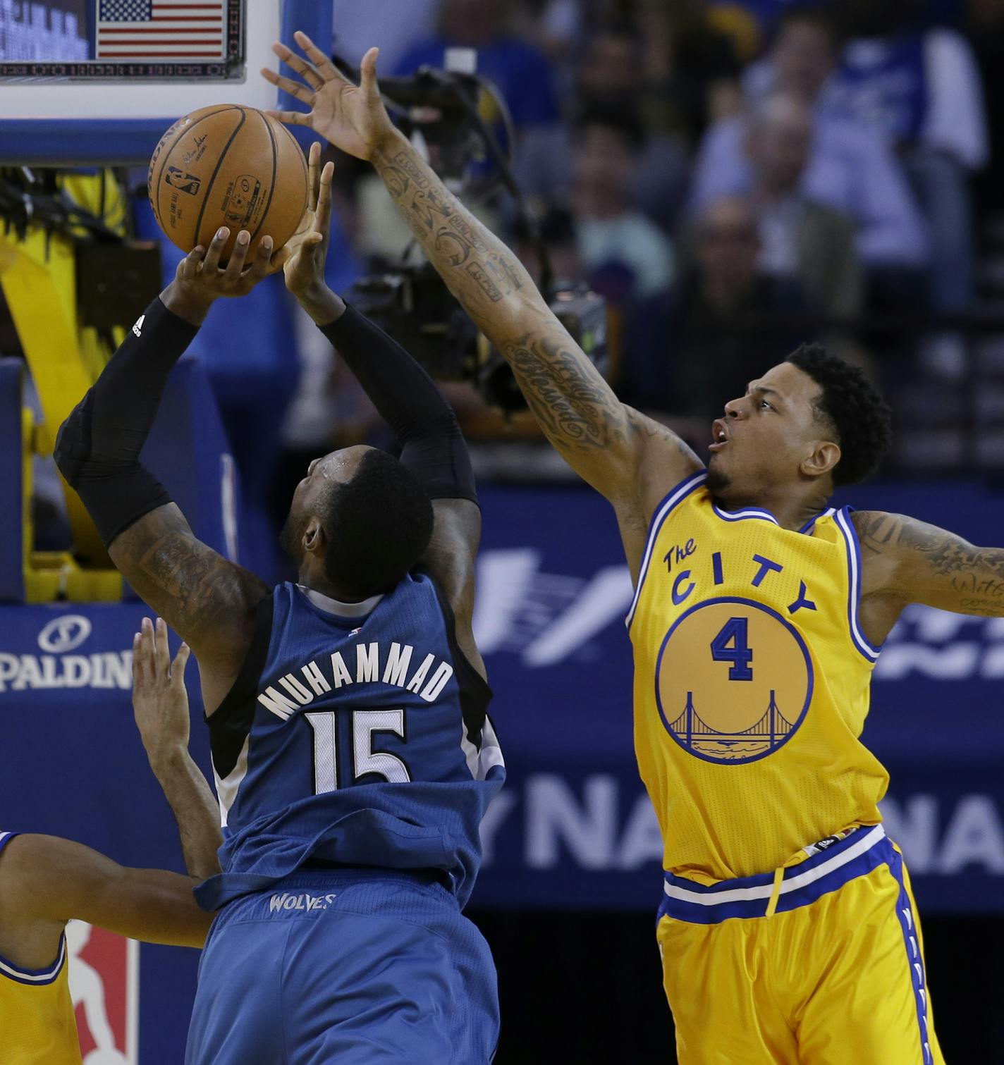 Golden State Warriors' Brandon Rush (4) defends on Minnesota Timberwolves' Shabazz Muhammad (15) during the second half of an NBA basketball game Tuesday, April 5, 2016, in Oakland, Calif. Minnesota won 124-117 in overtime. (AP Photo/Marcio Jose Sanchez) ORG XMIT: OAS326