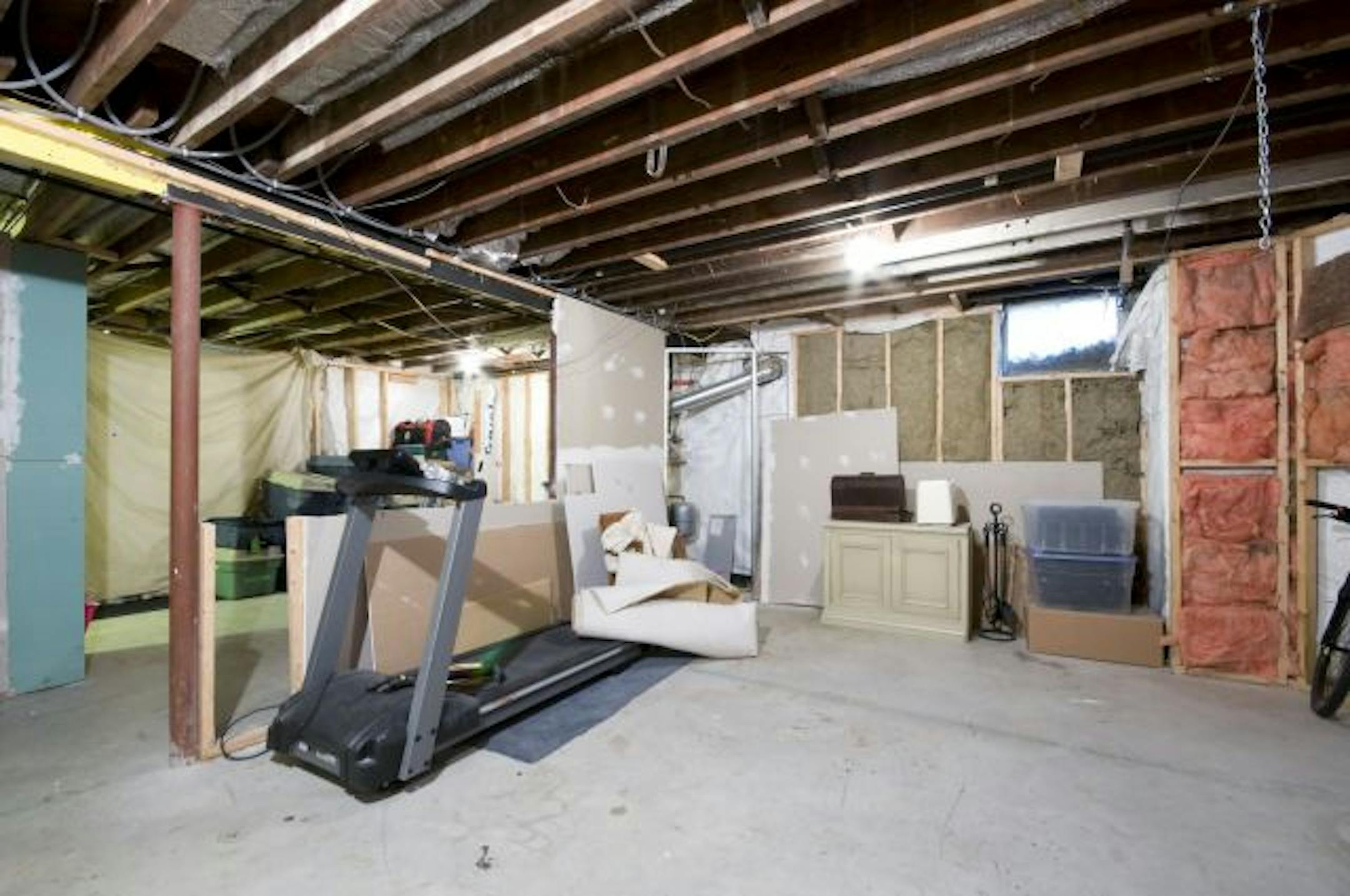 Before: This concrete and insulation-exposed basement needed everything.
