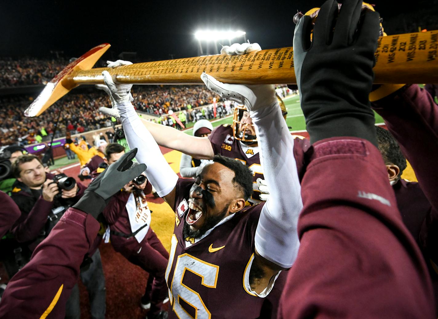 Minnesota Gophers defensive back Coney Durr (16) takes control of Paul Bunyan's Axe after an NCAA football game between the Gophers and the Wisconsin Badgers Saturday, Nov. 27, 2021 at Huntington Bank Stadium in Minneapolis, Minn. Minnesota defeated Wisconsin 23-13. ] AARON LAVINSKY • aaron.lavinsky@startribune.com