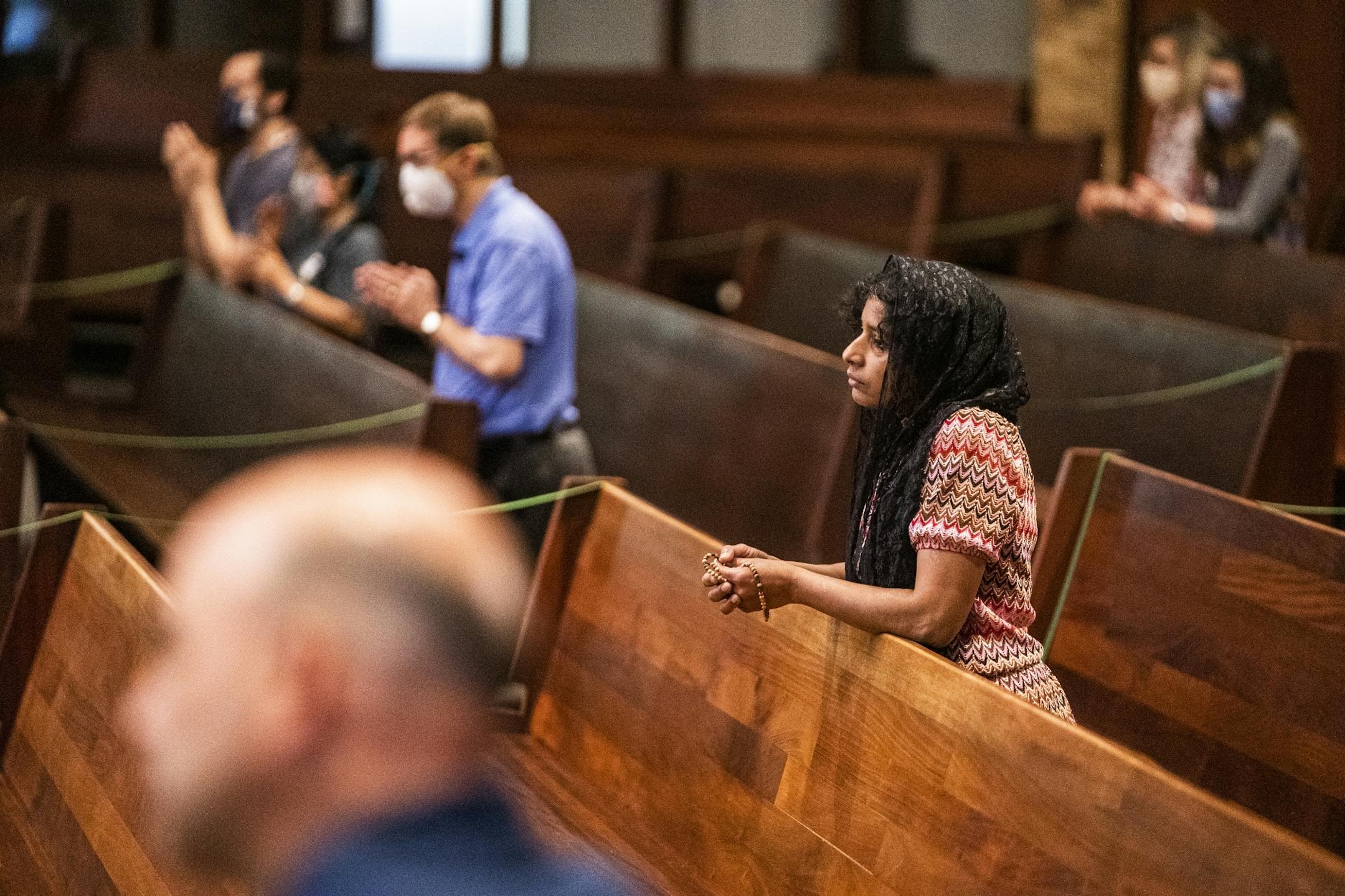 Parishioners including Latha Anderson were able to attend a service presided by Father John Paul Erickson as pews were closed off to allow social distancing and a maximum capacity of 250 or less than 25%.