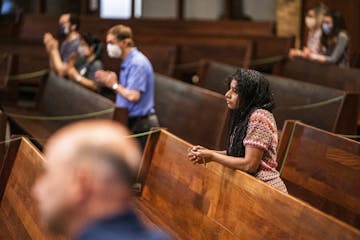 Parishioners including Latha Anderson were able to attend a service presided by Father John Paul Erickson as pews were closed off to allow social dist