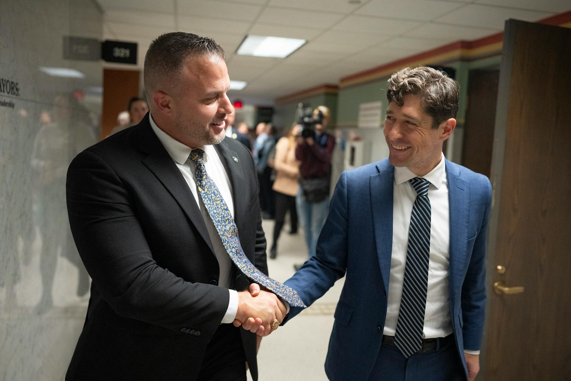 Brian O'Hara, left walked with Mayor Jacob Frey after he was voted in as the new Minneapolis police chief.