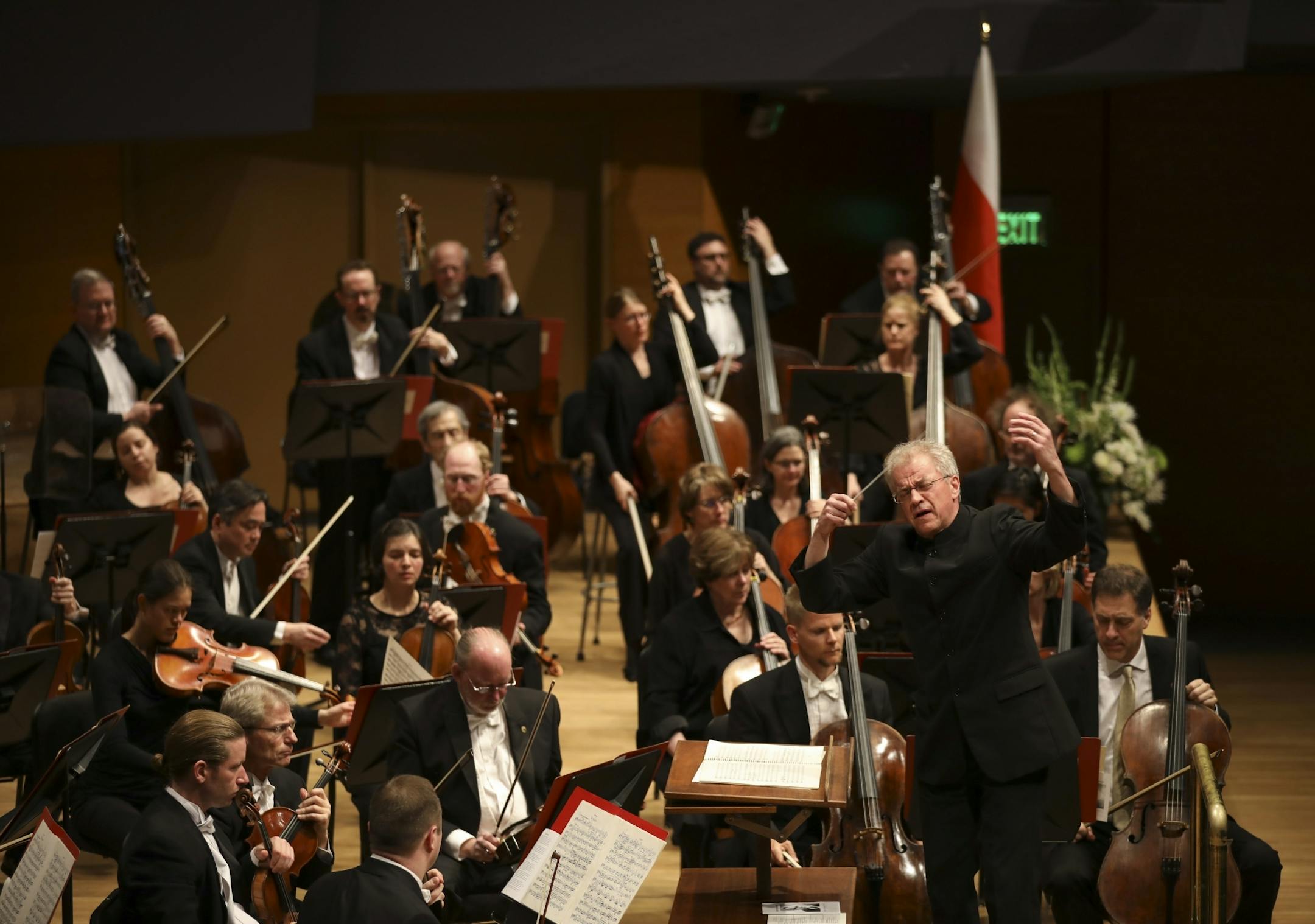 Minnesota Orchestra Music Director Osmo V�nsk� conducted the orchestra performing "Adagio," from Symphony No. 7 by Anton Bruckner. Long associated with Stanislaw Scrowaczewski, he first heard Bruckner's Symphony No. 7 coming from a window as a young boy and it moved him so deeply he fainted. The flag of Scrowaczewski's native Poland was onstage at rear.