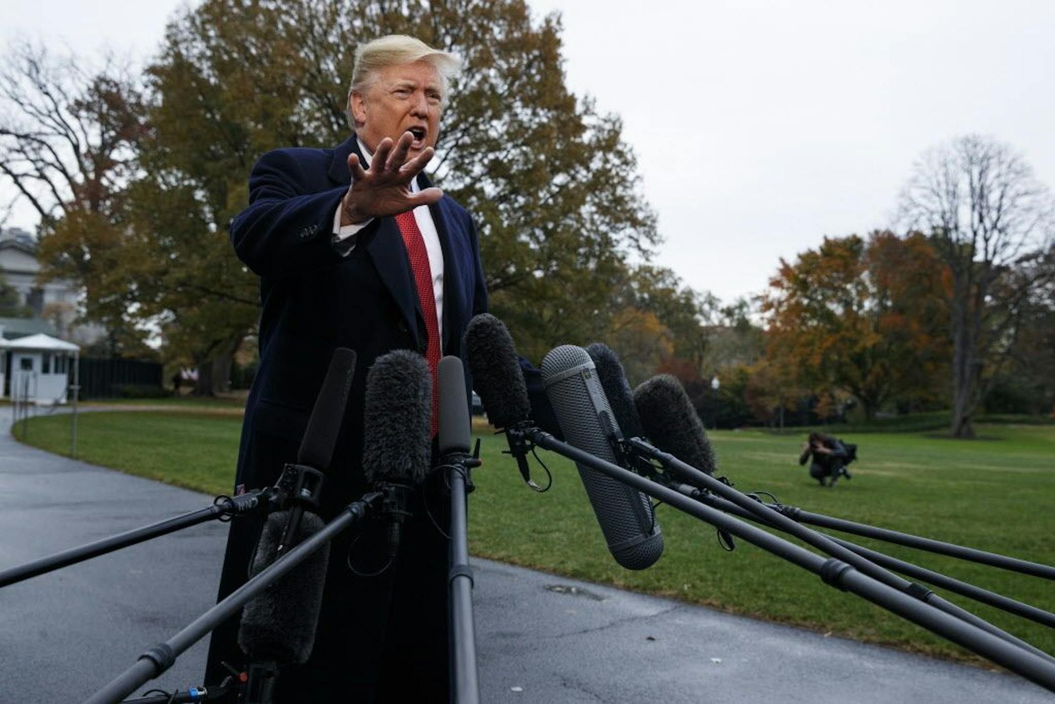 President Donald Trump talks with reporters before departing for France on the South Lawn of the White House, Friday, Nov. 9, 2018, in Washington.
