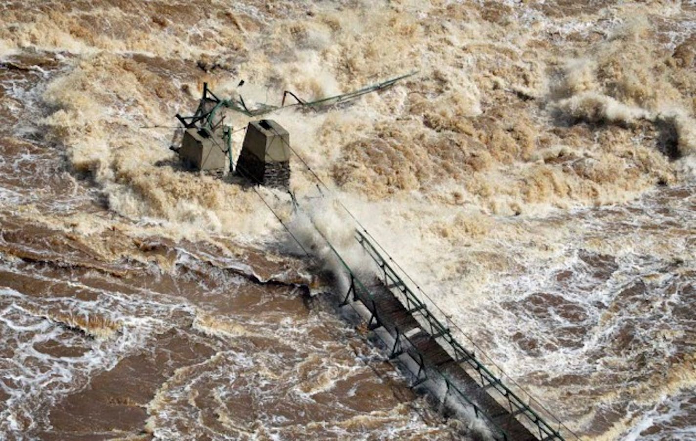 Water continues to rage in the St.Louis River as it flows through Jay Cooke State Park, washing out major sections of Hwy. 210 and here ripping out the swinging bridge in the park. ] BRIAN PETERSON ‚Ä¢ brianp@startribune.com Carlton, MN  - 06/21/2012