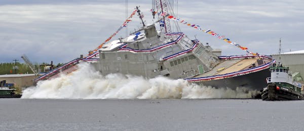 The USS Minneapolis-Saint Paul is launched into the Menominee River from Fincanteiri Marinette Marine in Marinette Wis., on Saturday, June 15, 2019. (